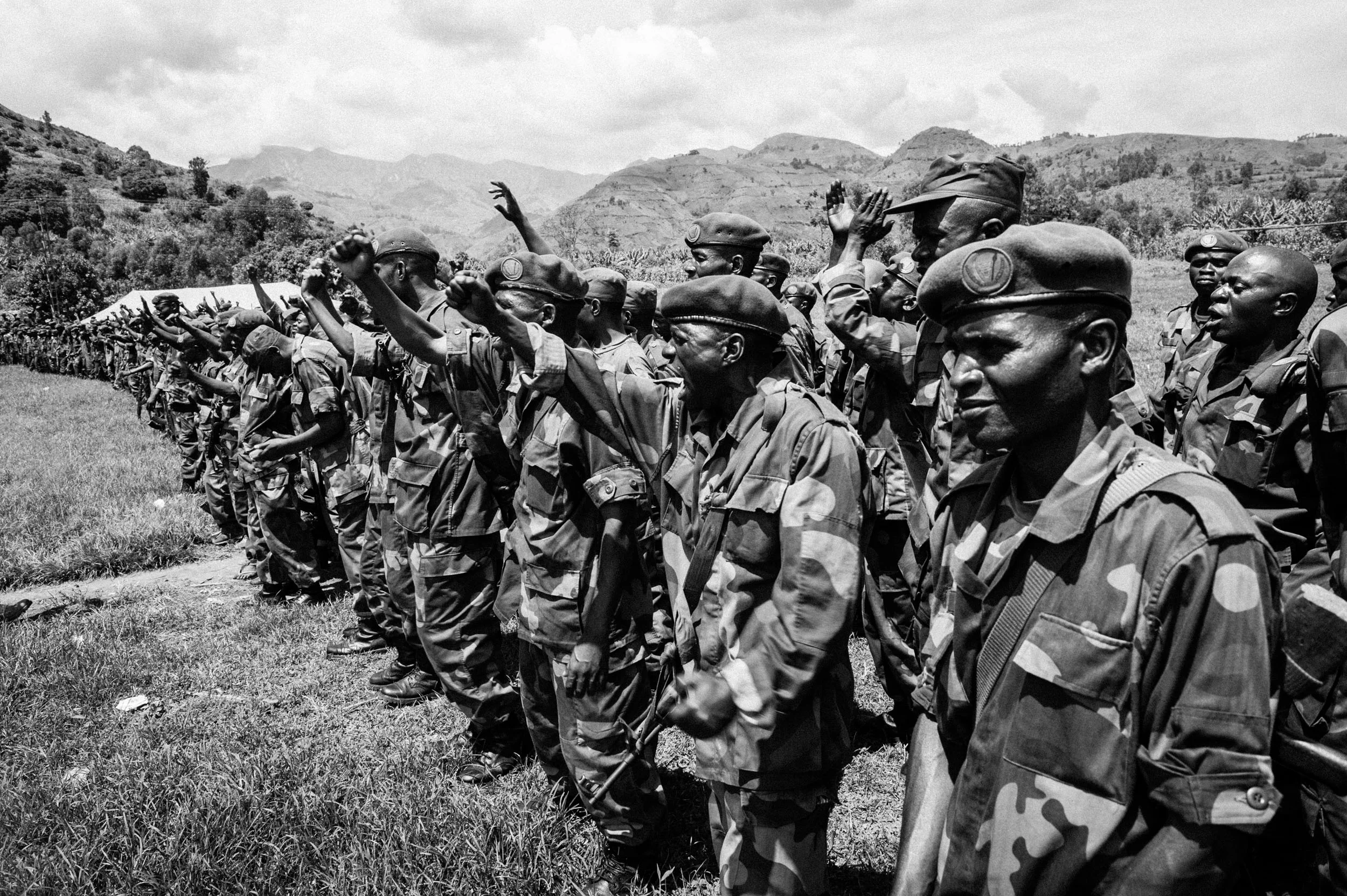  Troops from the recently retreated Armed Forces of the Democratic Republic of the Congo listen to General Francois Olenga, who flew in a helicopter from Kinshasha to rally his troops. 