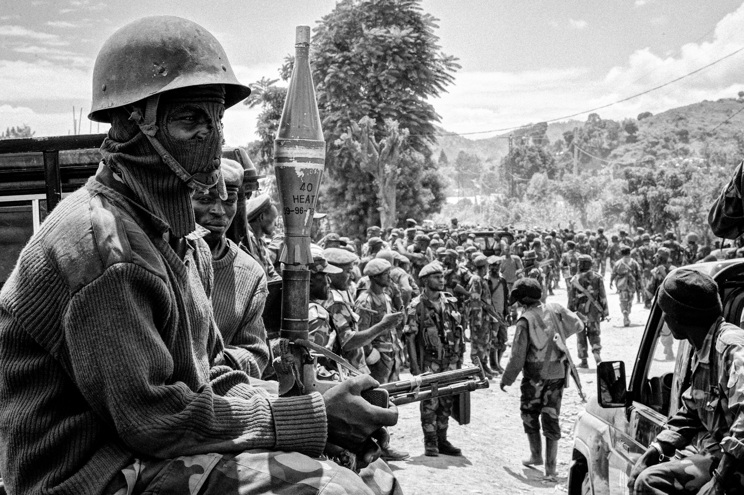  Troops from the recently retreated Armed Forces of the Democratic Republic of the Congo wait for a rally led by General Francois Olenga, who flew in a helicopter from Kinshasha to lift the moral of his recently retreated troops. 
