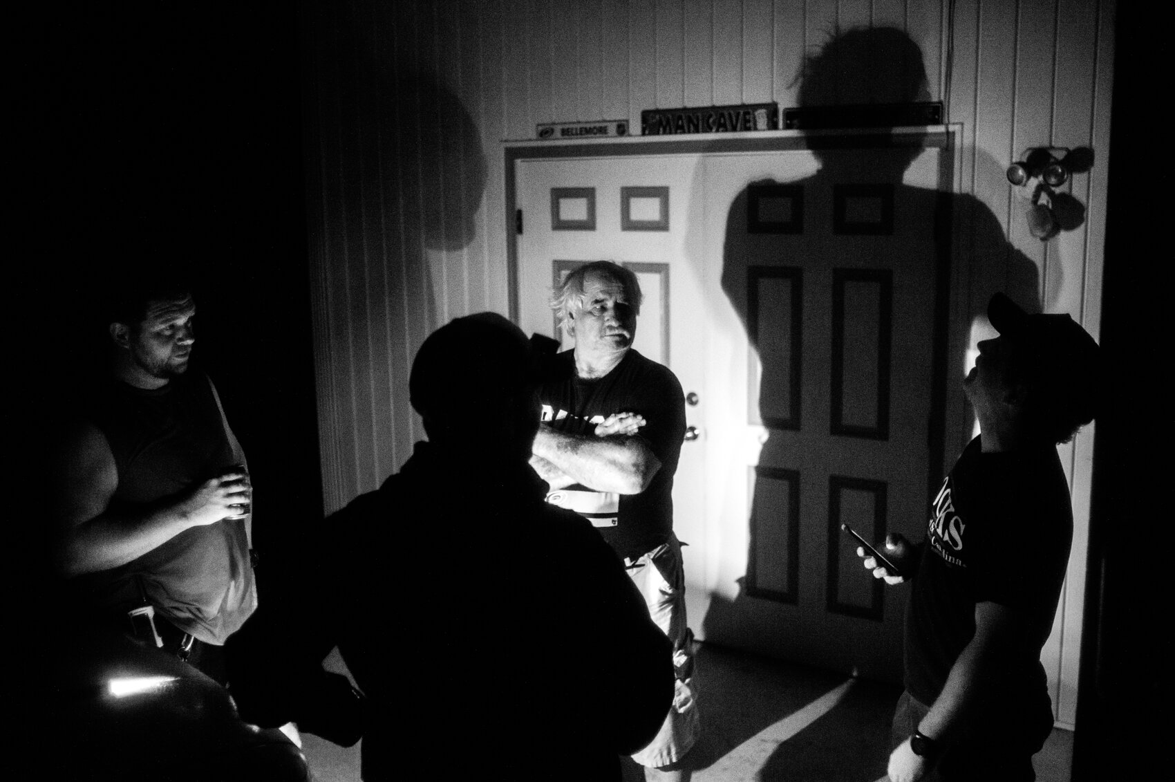  Carolina Beach residents talk inside a carport just over an hour before Hurricane Isaias makes landfall to the southeast at Ocean Isle, 9:51 p.m. Monday, Aug. 3, 2020. (Port City Daily photo/Mark Darrough) 