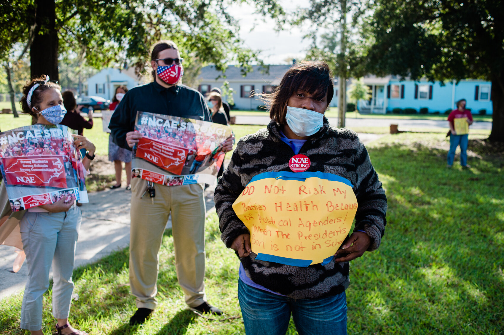  Sheri Ulcakova holds a sign in protest of the New Hanover County School Board’s discussion to reopen classrooms. She said the county should remain on a Plan C model until the entire country’s Covid-19 case numbers fall to an acceptable level. (Read 