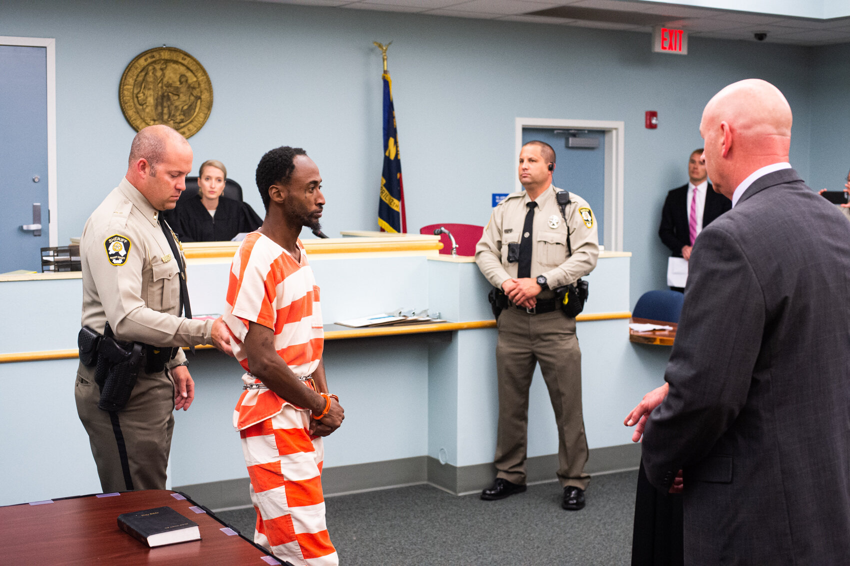  Raymond Brooks of Bladen County makes his first appearance at the Pender County Superior Court as Sheriff Alan Cutler, right, points to where he will stand before Judge Lindsey McKee. Brooks and his sister was accused for “heinous” robbery and murde