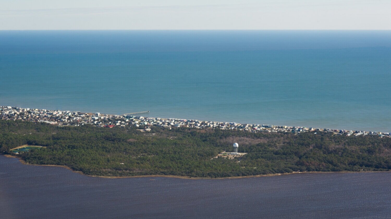  North of Bald Head Island at Kure Beach, the dark waters of the Cape Fear contrast with the aqua blue of the Atlantic. (See the photo essay   here  .) 