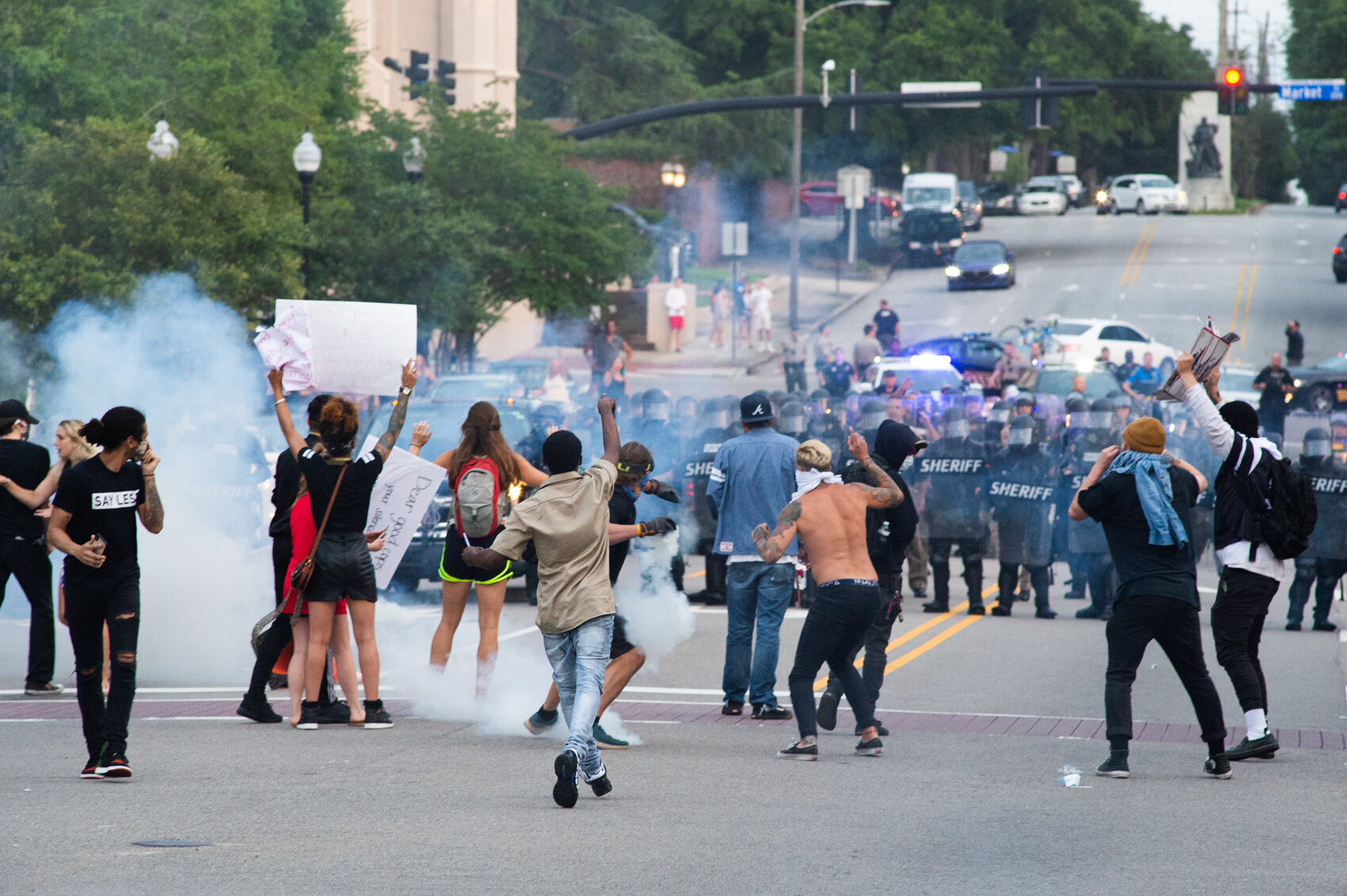 A protestor throws a tear gas canister back towards the line of sheriff’s deputies wearing riot gear, May 30, 2020. Most of the crowd of protestors outside City Hall had dispersed after the first volley of tear gas canisters fired by the deputies. (