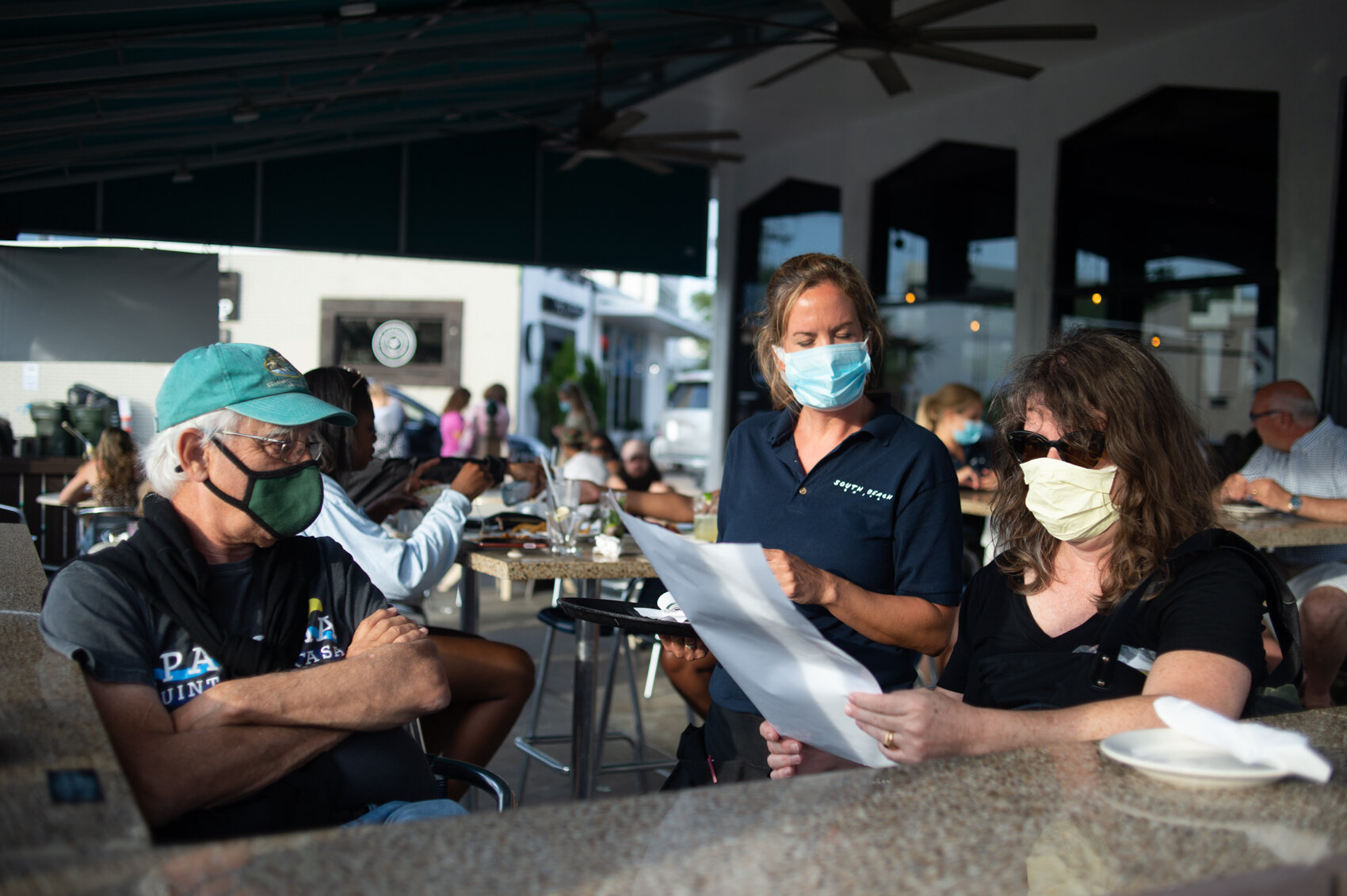  Customers order at a restaurant in Wrightvsille Beach following Governor Roy Cooper’s executive order signed on May 20 to reopen at 50% capacity – 66 days after restaurants were closed due to the Covid-19 pandemic. 