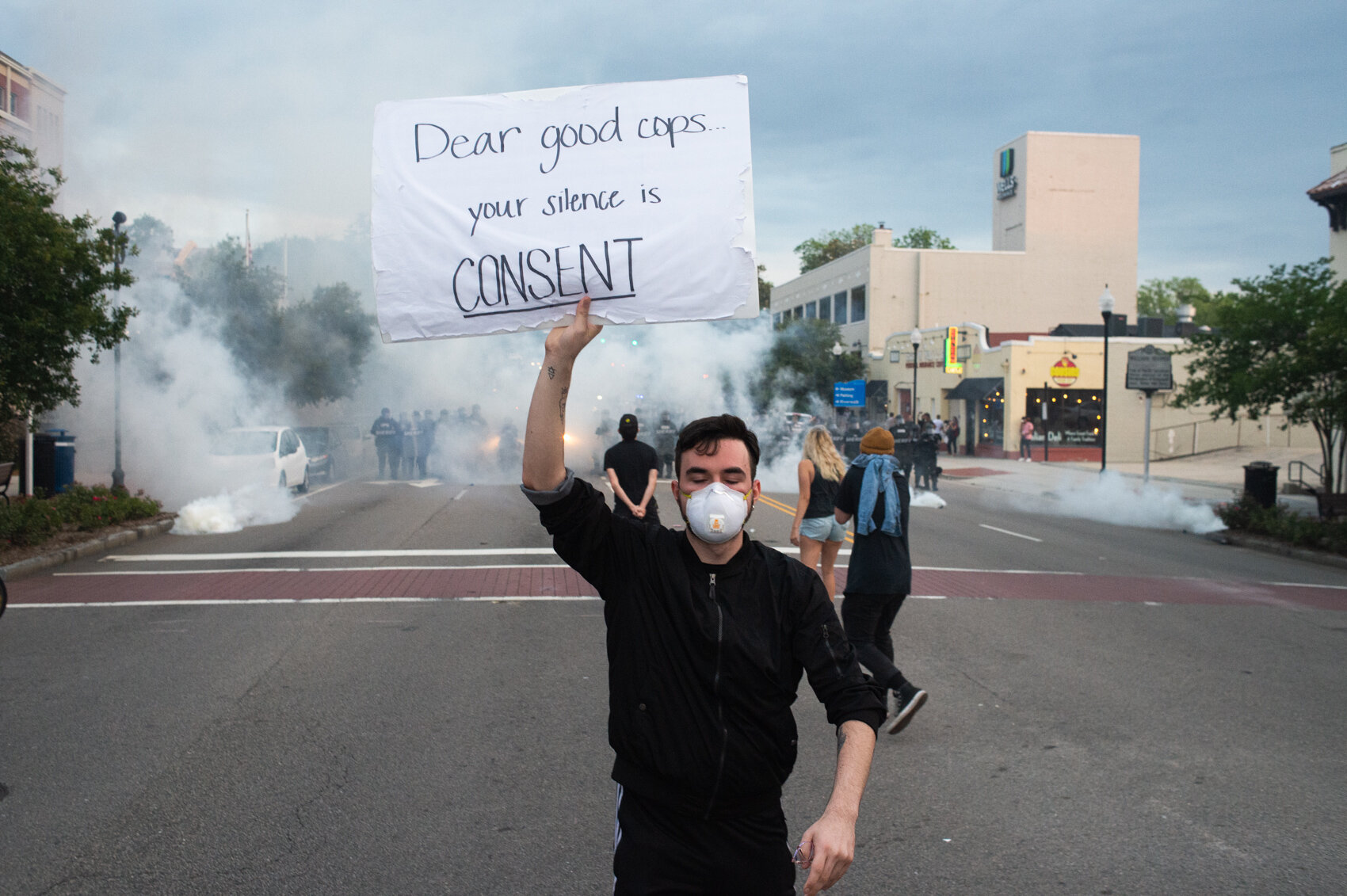  A protestor holds up a sign as he and others refuse to disperse. (Read the story and photo essay   here  .) 