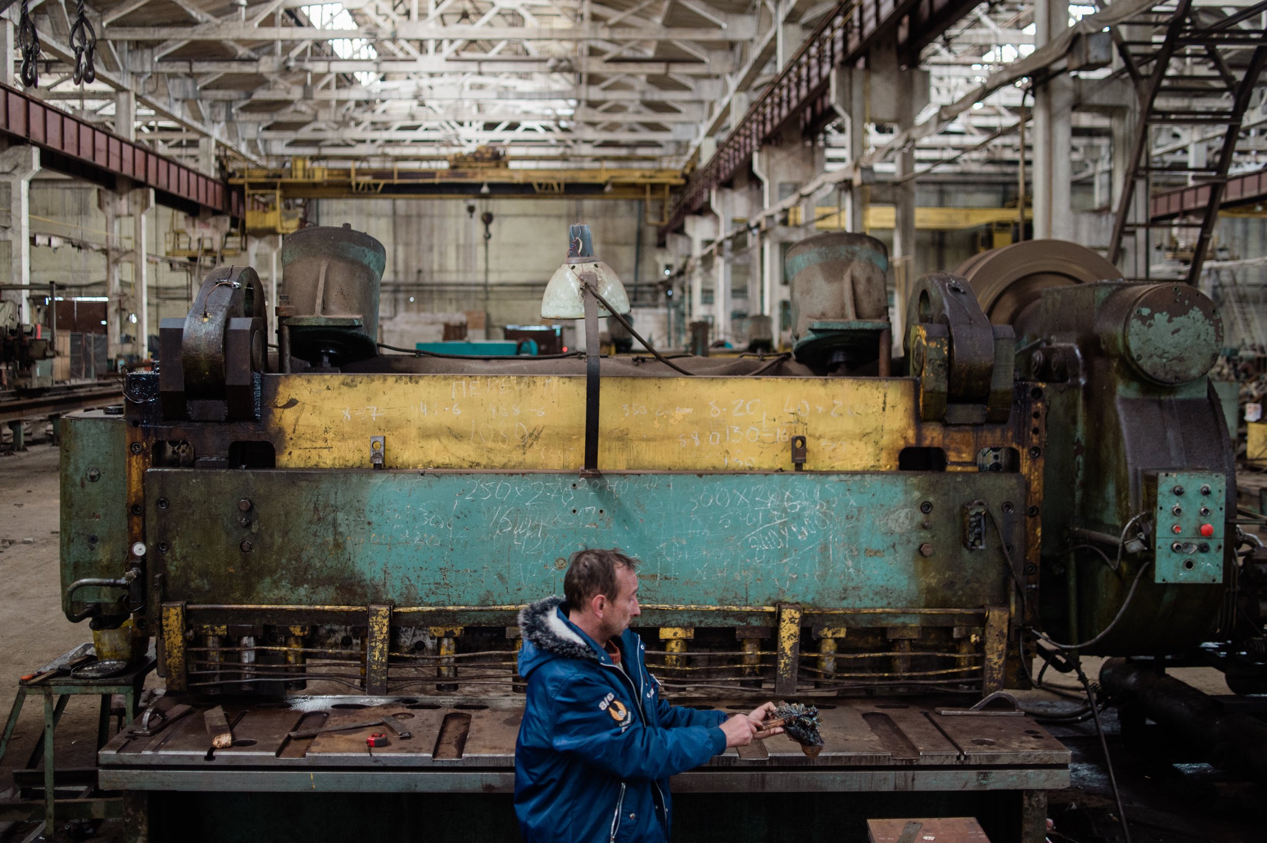  A man from Irpin, near the Ukrainian capital Kyiv, operates a machine that cuts steel for the production of bulletproof vests inside a large manufacturing facility in western Ukraine. 