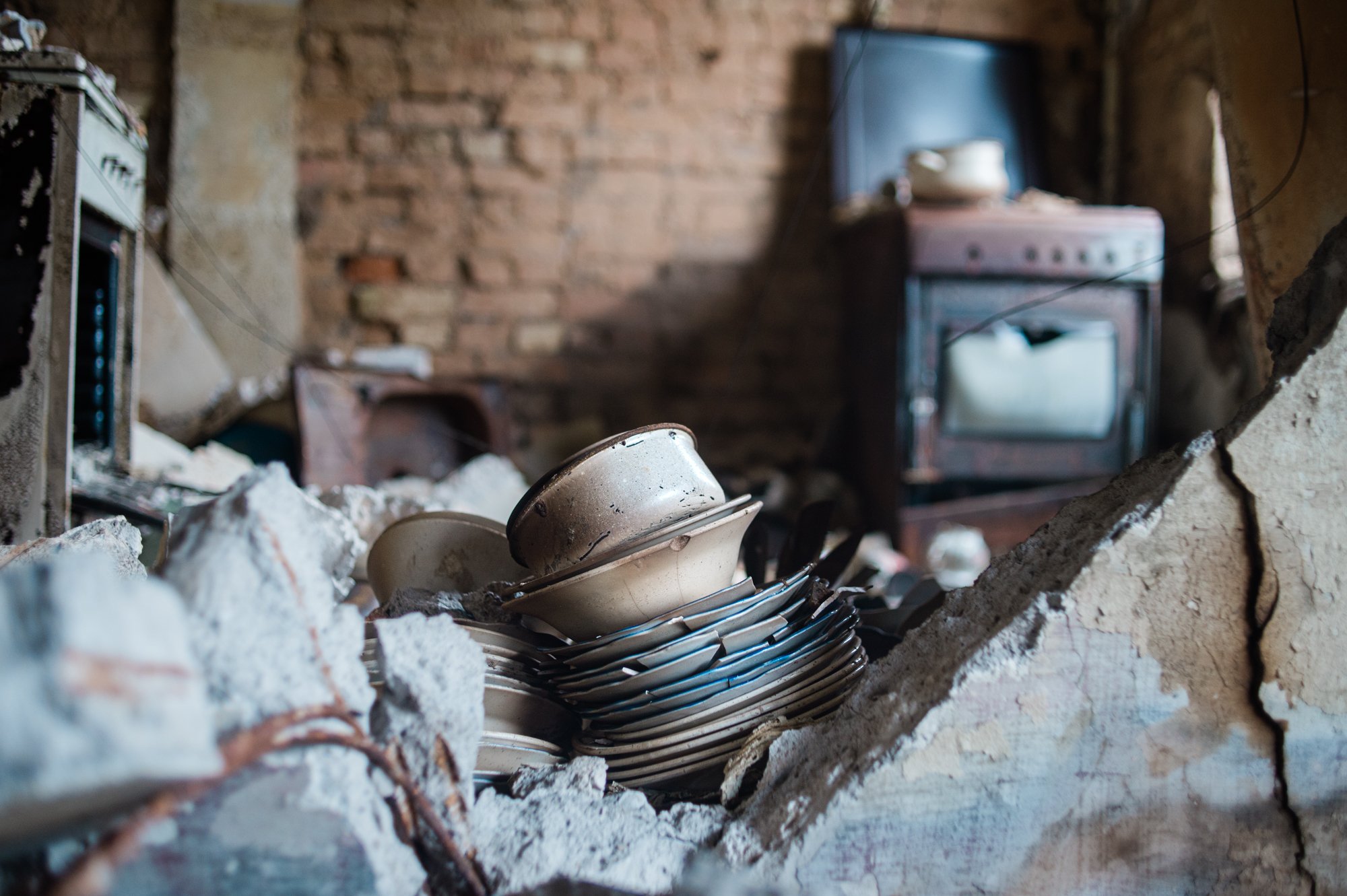  A stack of bowls and plates lie atop the ruins of what was a kitchen in a building destroyed by Russian missiles and artillery in the Kyiv suburb of Irpin. 