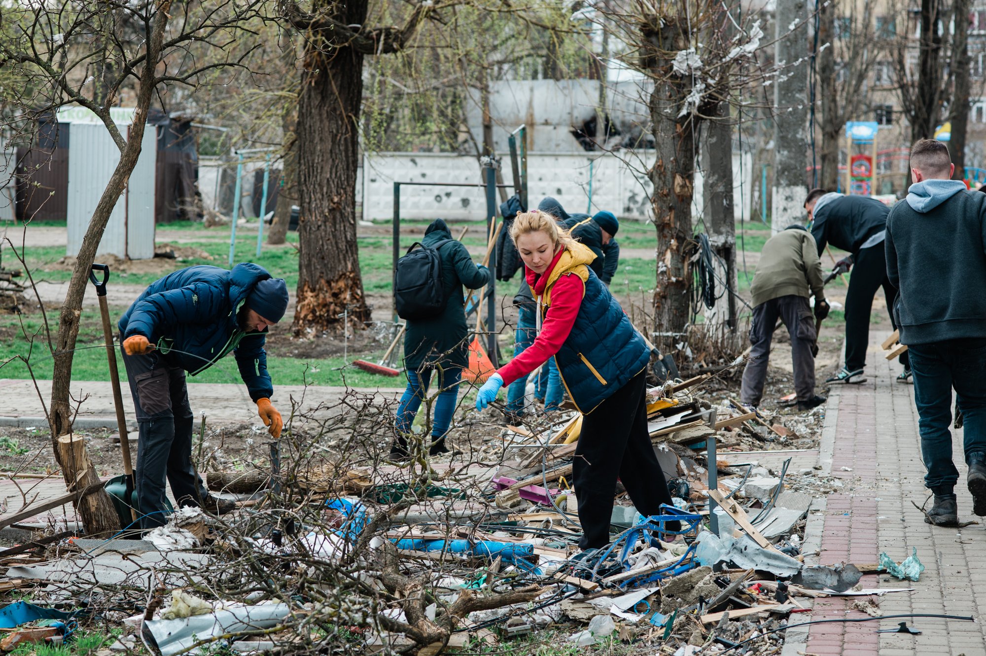  People in the Kyiv suburb Irpin remove debris near buildings heavily damaged by Russian artillery and missiles. 