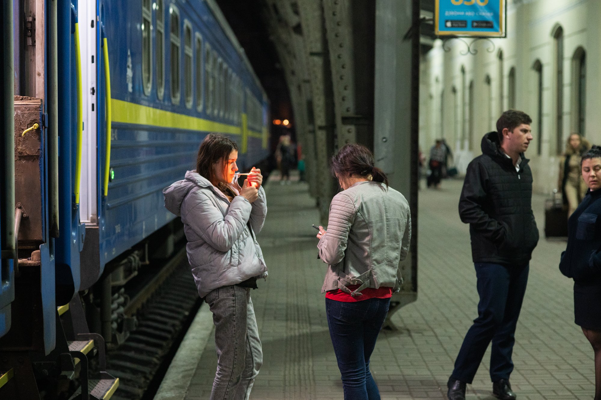  Passengers at the central train station in Lviv disembark from a train arriving from the Polish border town of Przemyśl just before midnight on April 14, 2022. Ukraine's border force said on Wednesday more than 870,000 Ukrainians have returned to th