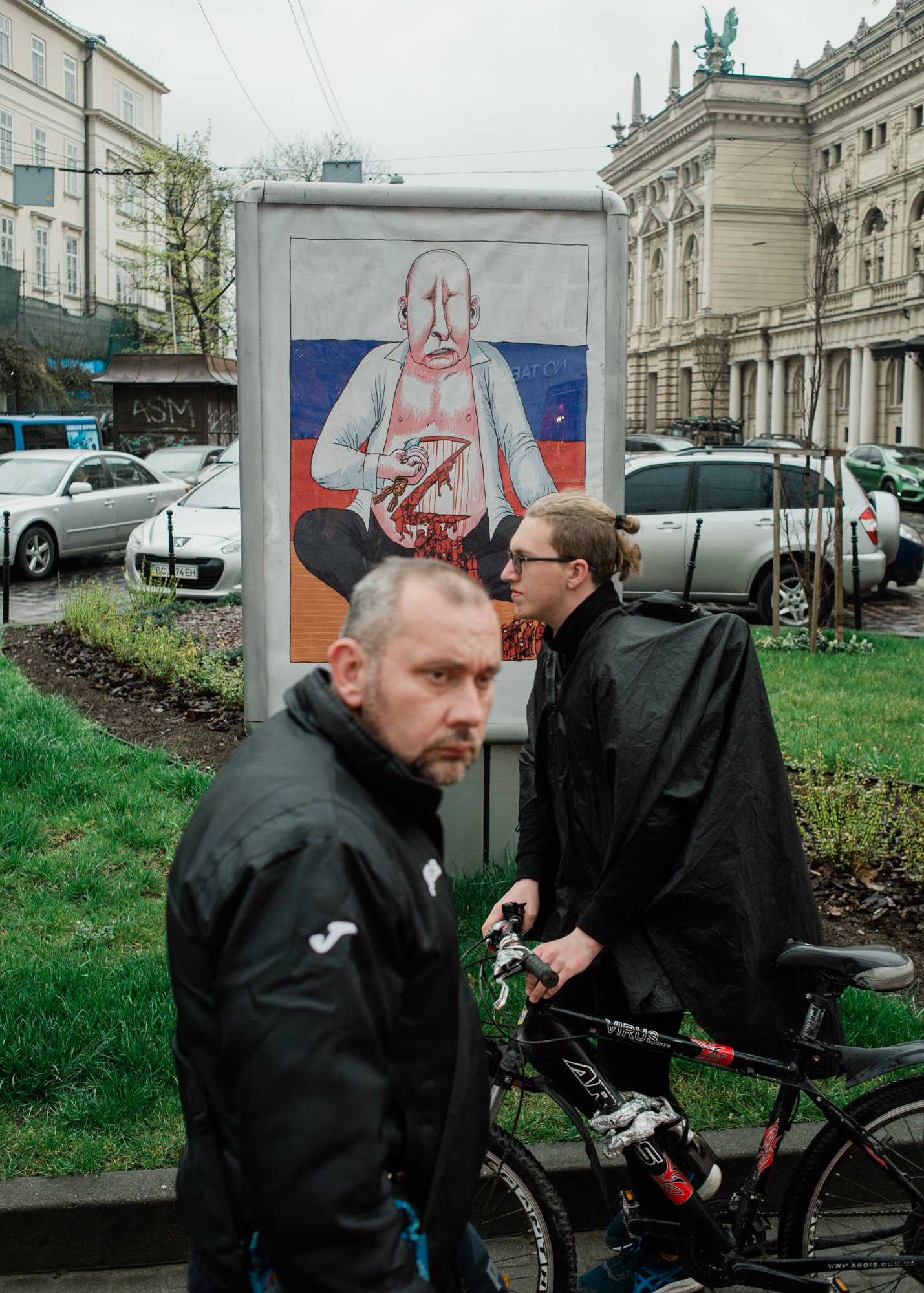  A man walks by a poster depicting Russian President Vladimir Putin carving the letter “Z” into his stomach, as troops colored in red pour out of the wound. The Russian Ministry of Defence said in early March that the “Z” symbol stood “for victory.” 