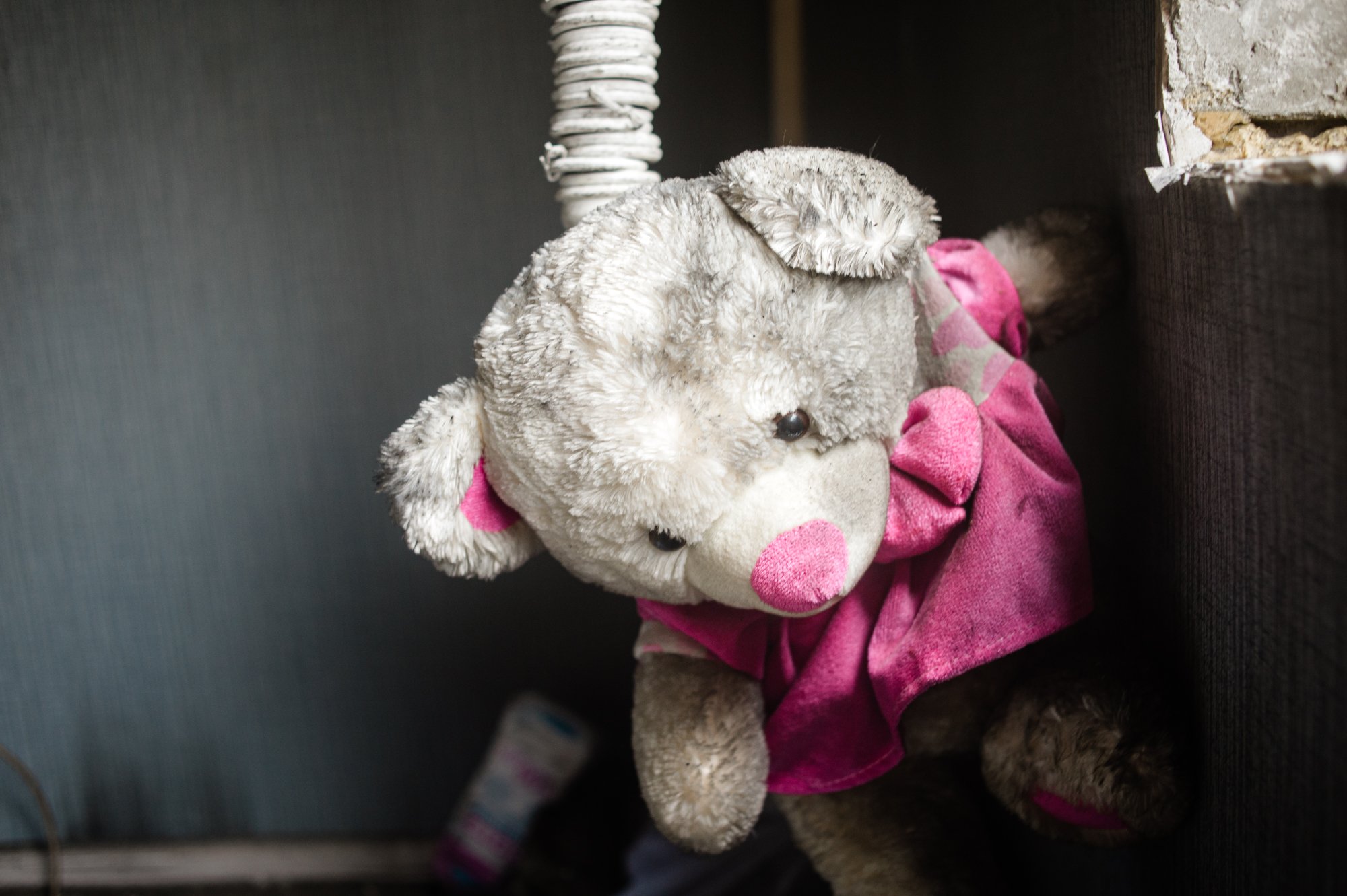  A stuffed bear hangs from a pipe in a destroyed apartment building in Irpin, a suburb of Kviv. 