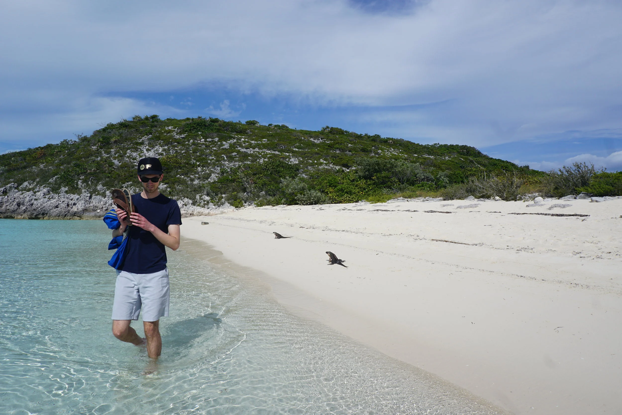 Ari shying away from curious iguanas at Bitter Guana Cay