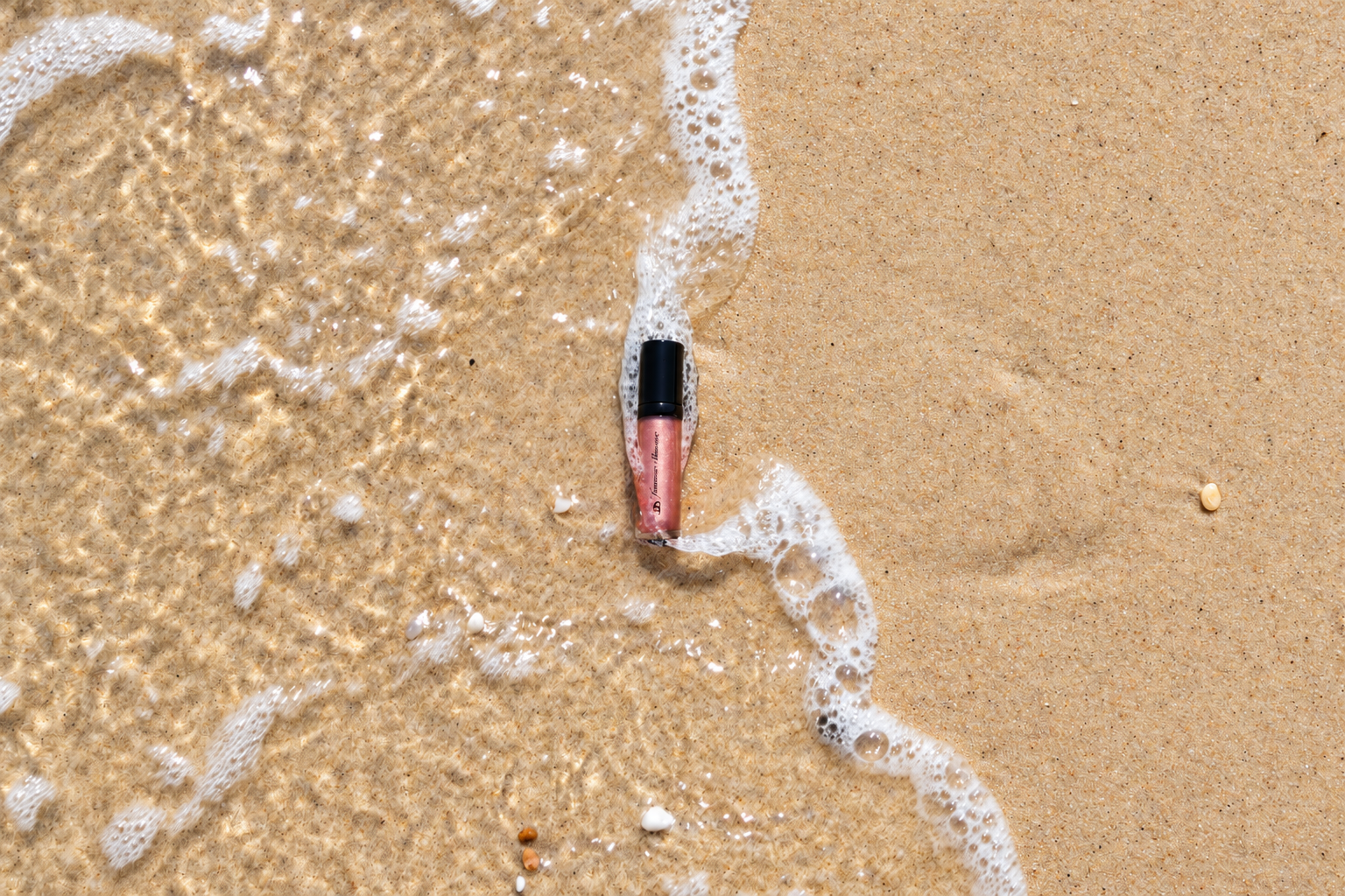 Shimmering Pink Lip Gloss by the Sea.png