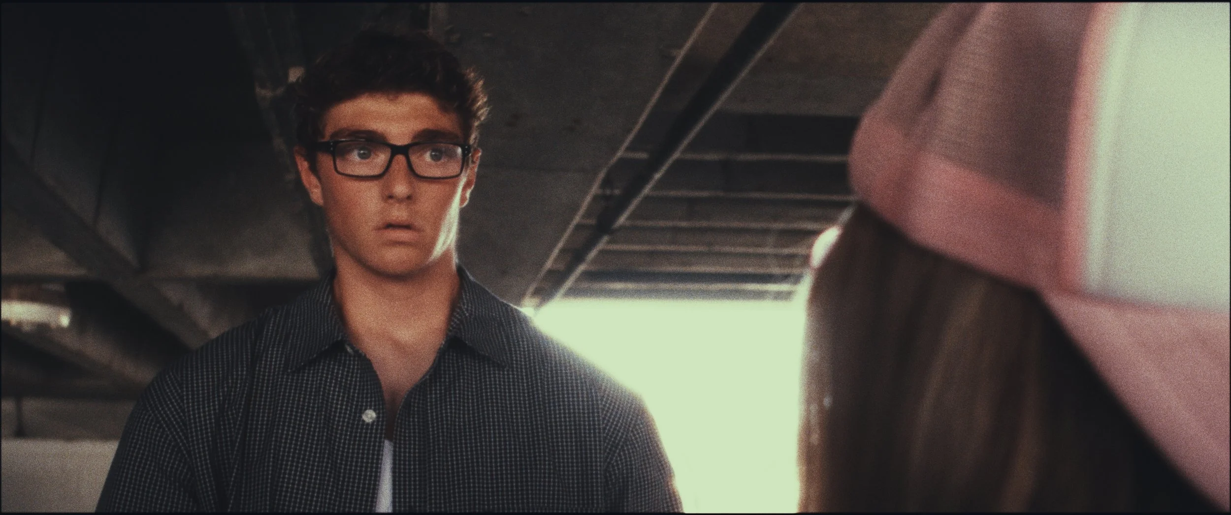 Man in glasses looking past a woman in a pink cap, Five Finger Stakeout, Omaha 48 Hour Film Challenge 2026