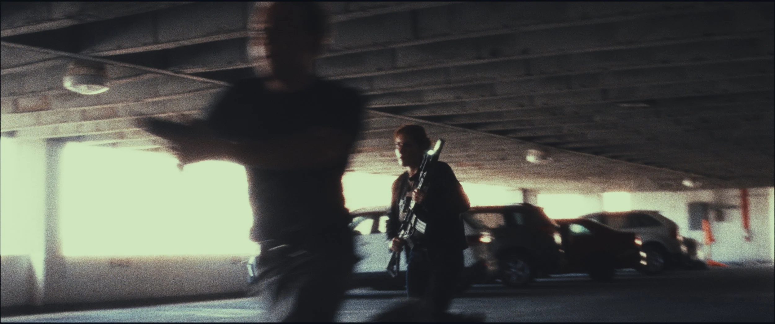 Blurred figure running through a parking garage, Five Finger Stakeout, Omaha 48 Hour Film Challenge 2026