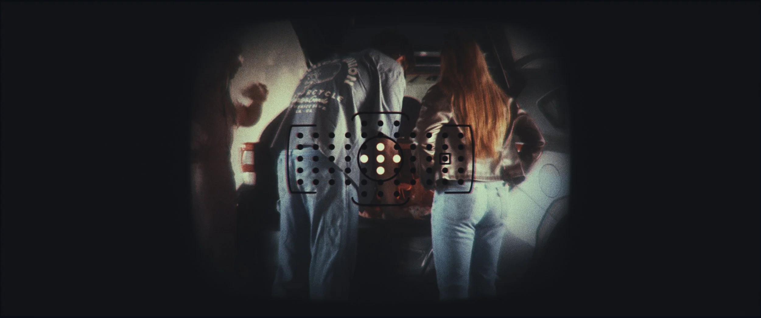 Vignetted point-of-view shot of figures standing in a parking garage, Five Finger Stakeout, Omaha 48 Hour Film Challenge 2026