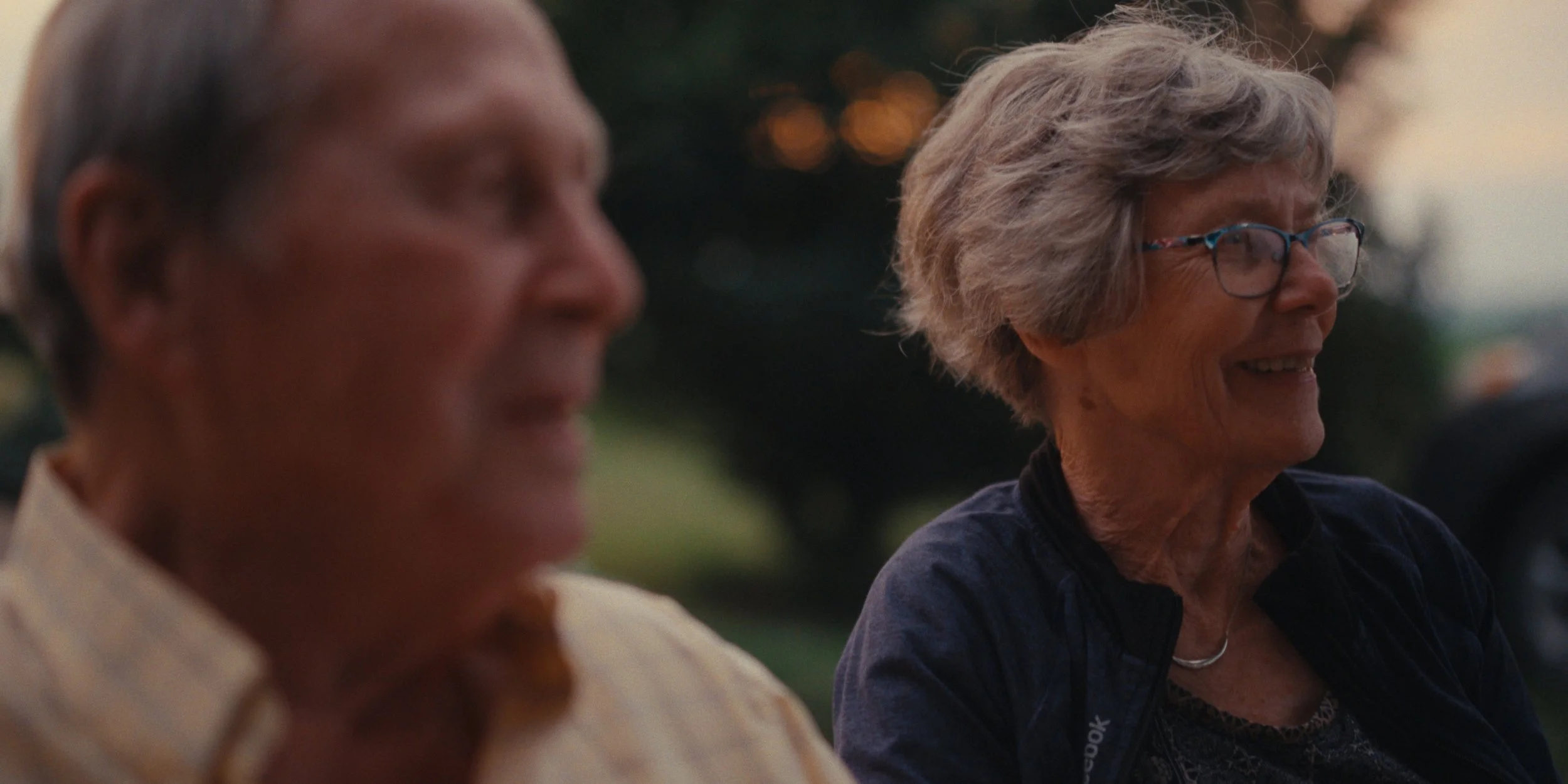 Portrait of an older farming couple smiling outdoors at dusk, still from a Folsom Lake Solar commercial shot in Mills County, Iowa by director of photography Cole Mowery