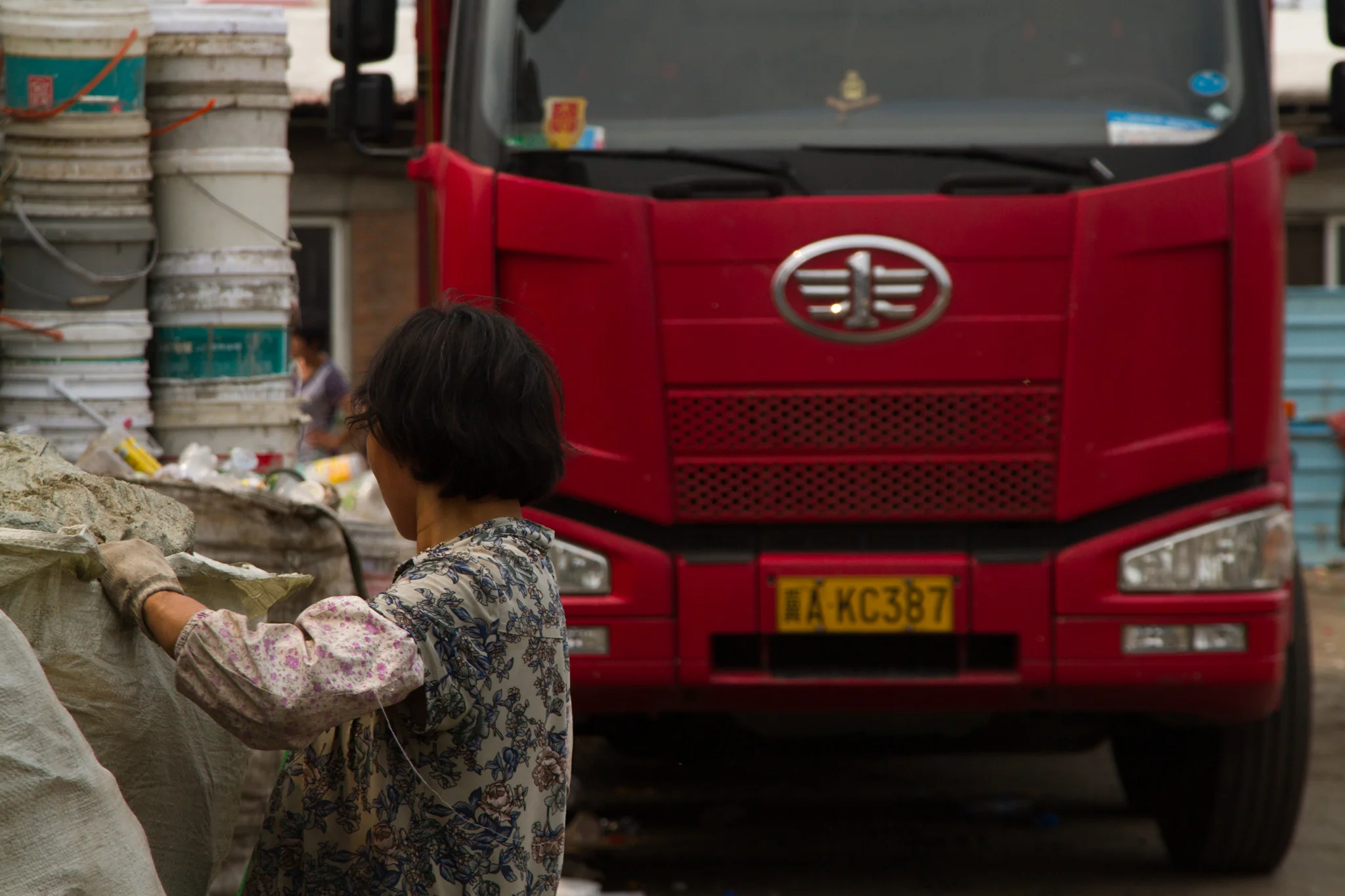 A migrant worker from Gushi sorts trash in Lang Dai, Beijing.