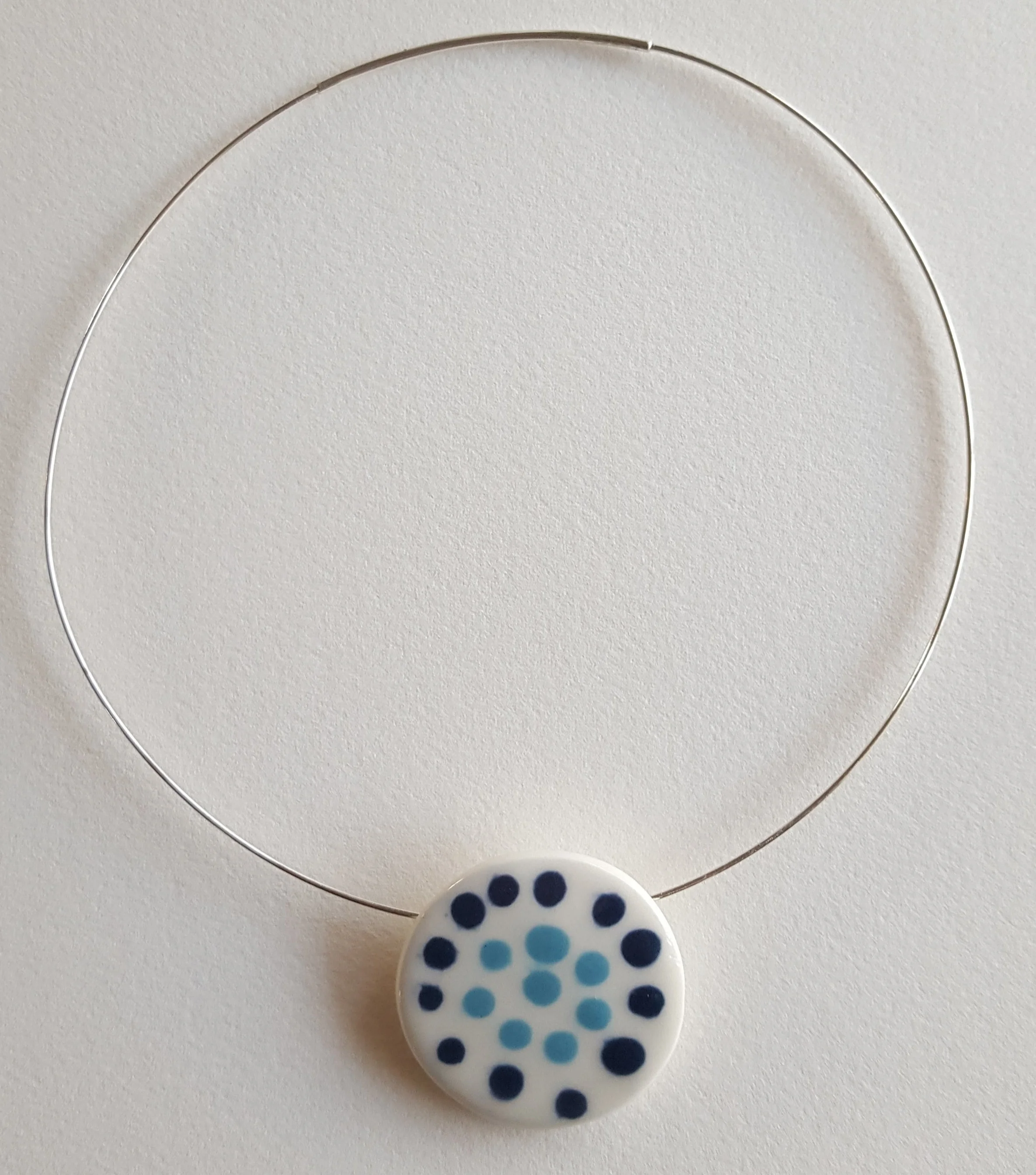 Porcelain Slip decorated Disk on a Sterling silver neck wire