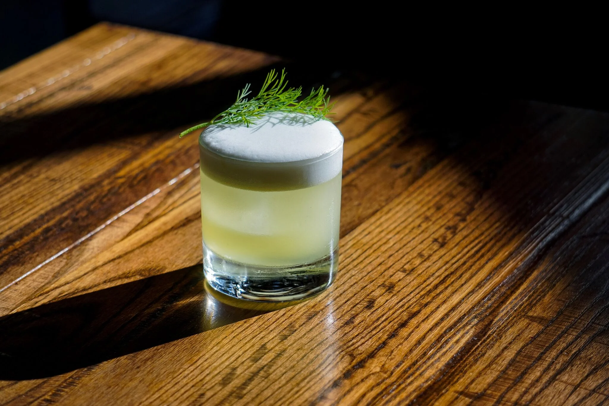 Cocktail garnished with fresh dill.