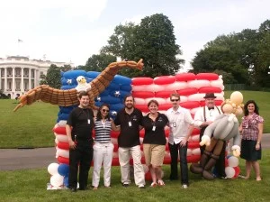 A balloon version of the US flag with the team that made it.