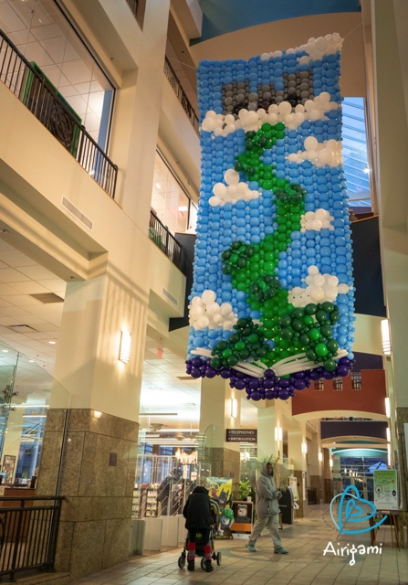 This Airigami Bubble Mural™ was constructed by the attendees of Maker Faire Rochester and hung in the Central Library of Rochester for the month of December. This depiction of Jack’s beanstalk rising out of a library book is just the first Airigami mural to be displayed in this location.