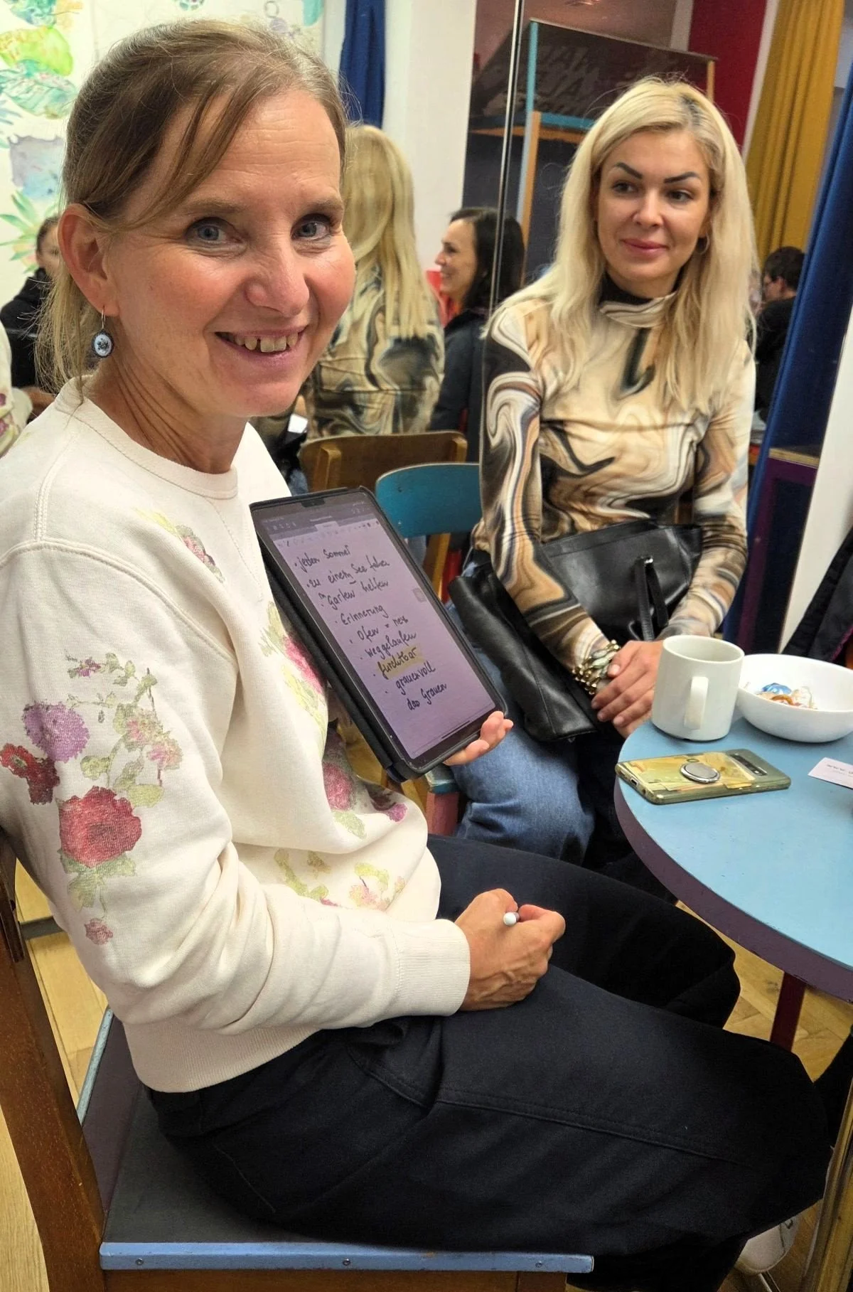 Ehrenamt für Senioren Berlin - Frau blickt in die Kamera mit geschriebenen Worten auf einem Netbook