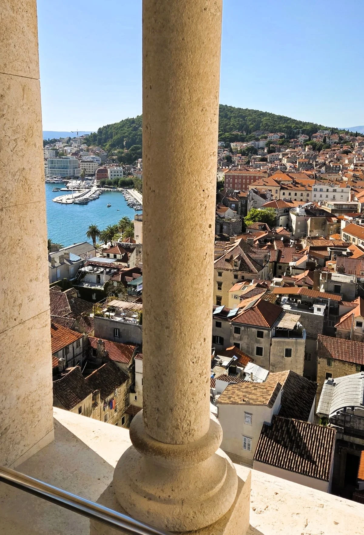 Split-Reisebericht, Blick zwischen Säulen vom Glockenturm auf Stadt und Yachthafen von Split