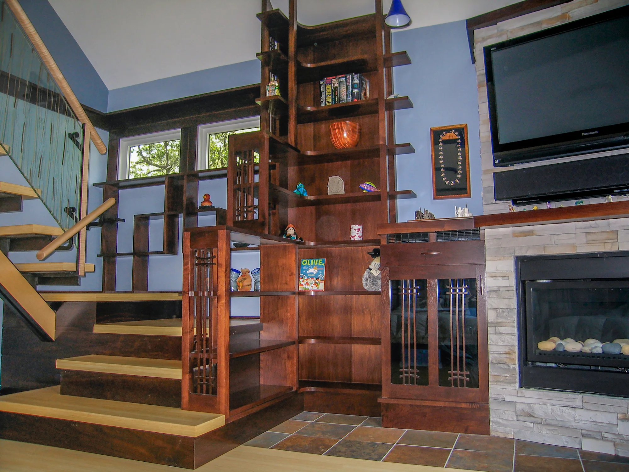 bookshelf, stair and fireplace