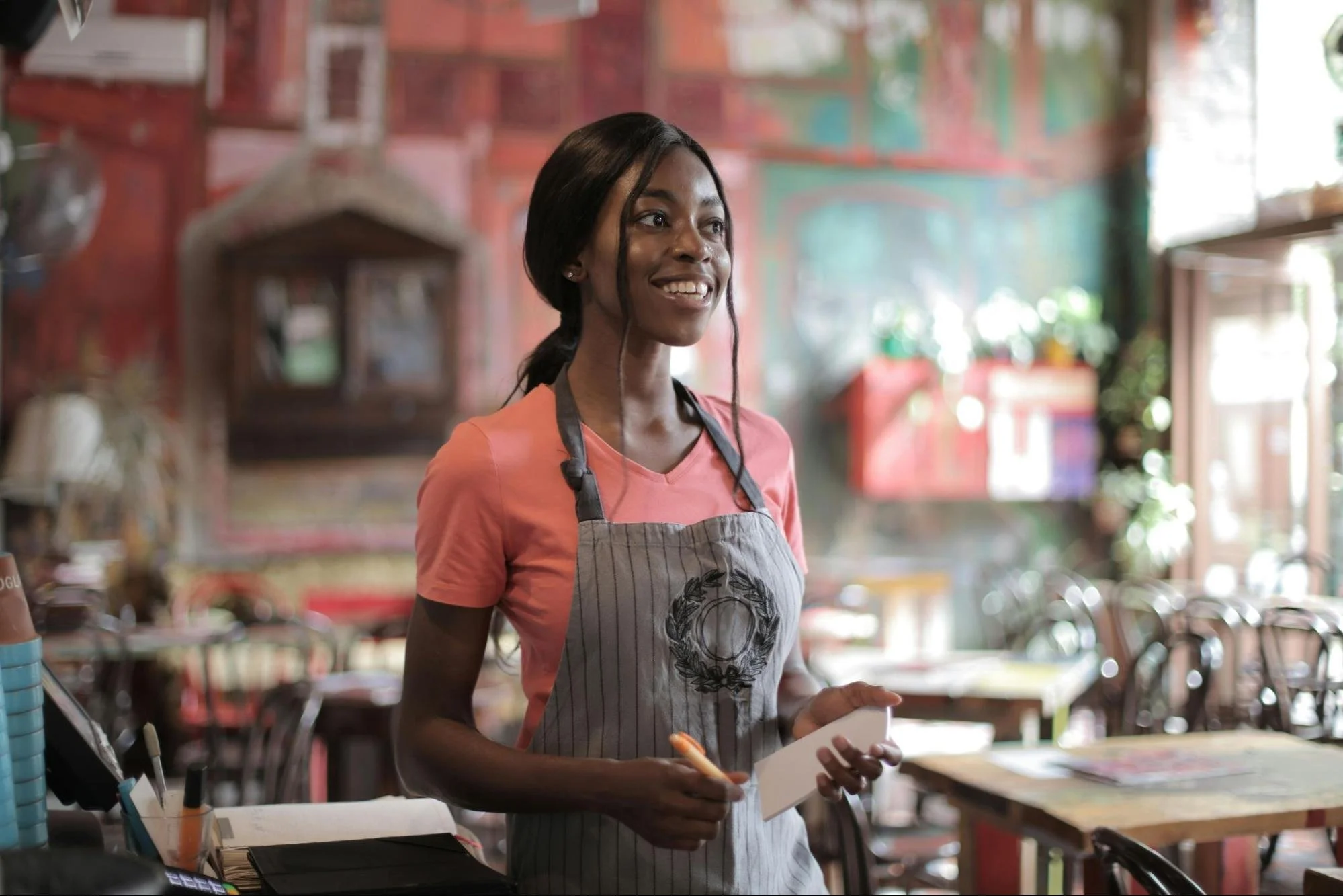 Picture of young woman smiling working in cafe