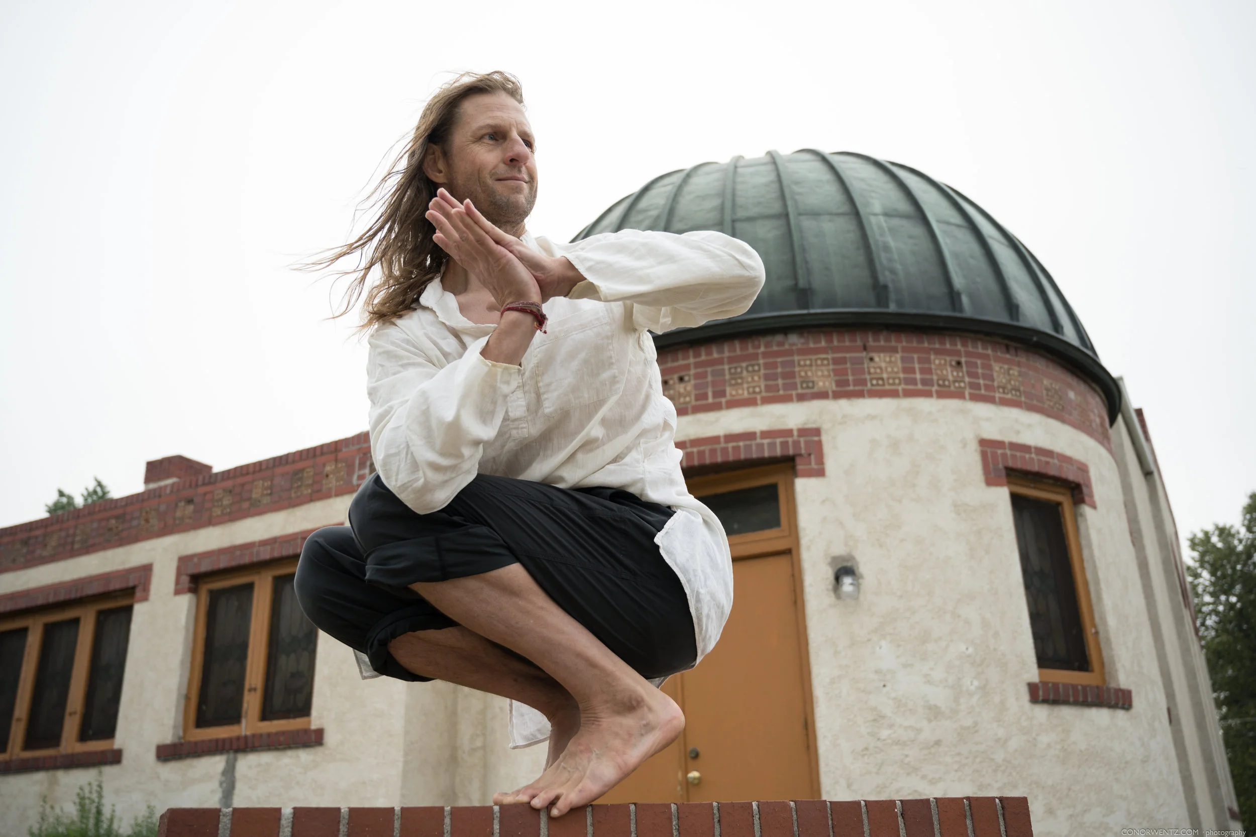 Derik was first introduced to yoga in 1991 while on a rogue trip to India just after highschool. As he studied asana, yoga philosophy and meditated on the shores of the Ganges. A whole new world opened up inside of him and the tone for his entire adult life was set. Over the ensuing decades, he studied with world-renowned asana and meditation teachers, completed multiple 200 and 300-hour trainings, and returned to India many times to deepen his study. He considers Baba Hari Dass and Yogarupa Rod Stryker to be his primary teachers. In 2003, he and his wife (Dr. Brenna Hatami) started Axis Yoga Trainings in Denver Colorado. Axis, soon to be the “Denver Yoga Underground”, is a school dedicated to workshops and yoga teacher trainings and is a safe haven for a diversity of people who may prefer to practice outside of a studio setting. Personally, he believes that we each have a purpose and that life circumstances lead us an evolutionary journey to understand ourself and the role we must play. All experiences, whether “positive” or “negative” are an opportunity to enrich our spirit and character. Yoga aids in that process.