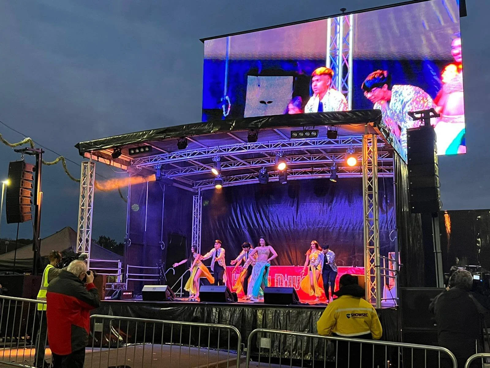 Mobile event stage setup with large LED video screen display and dancers performing