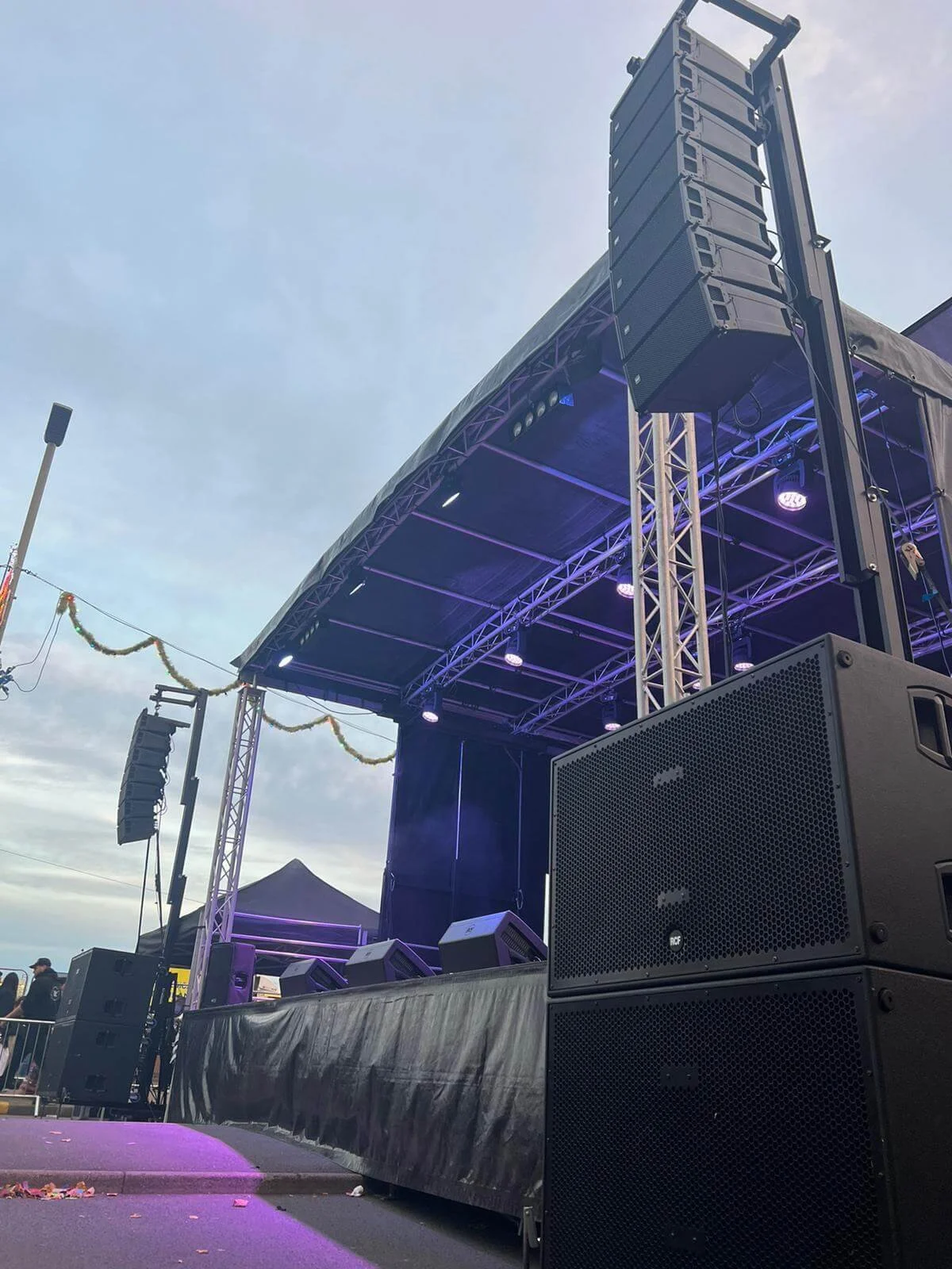 Professional concert sound system line array speakers and subwoofer hire setup on stage