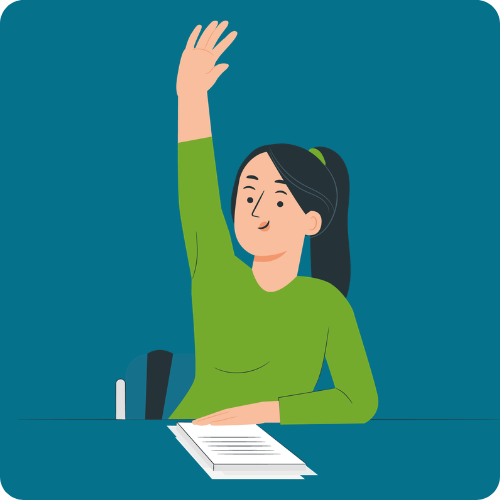 A teacher is sitting at a desk with her hand raised. There are some documents in front of her on the desk.