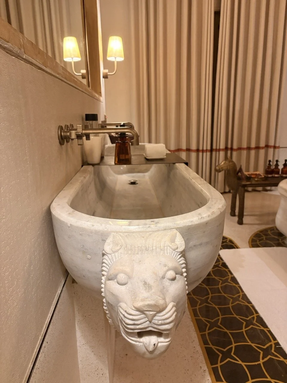 hand-carved marble basin with a lion gargoyle.jpeg