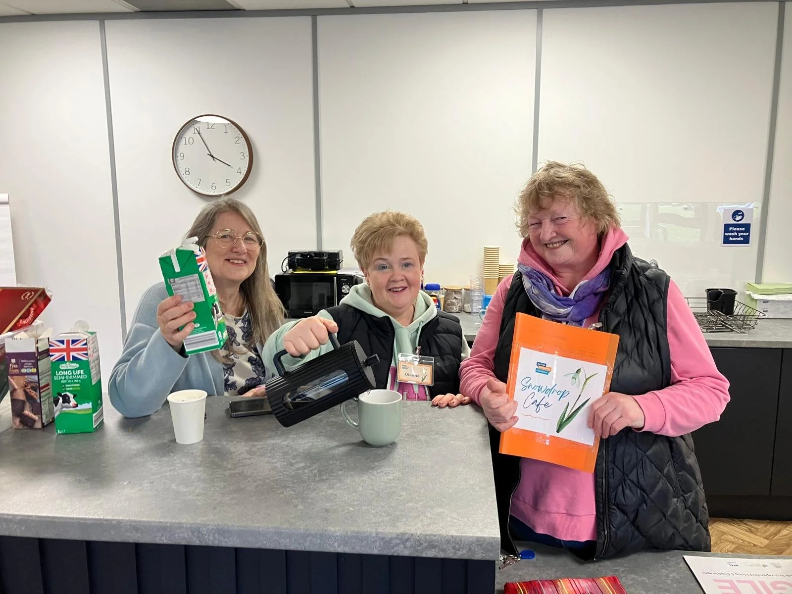 Cafe volunteers serving hot drinks