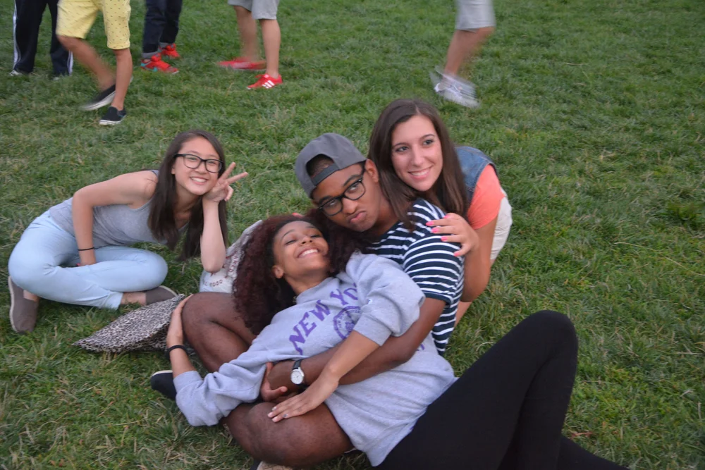 Students and chaperones near a charter bus