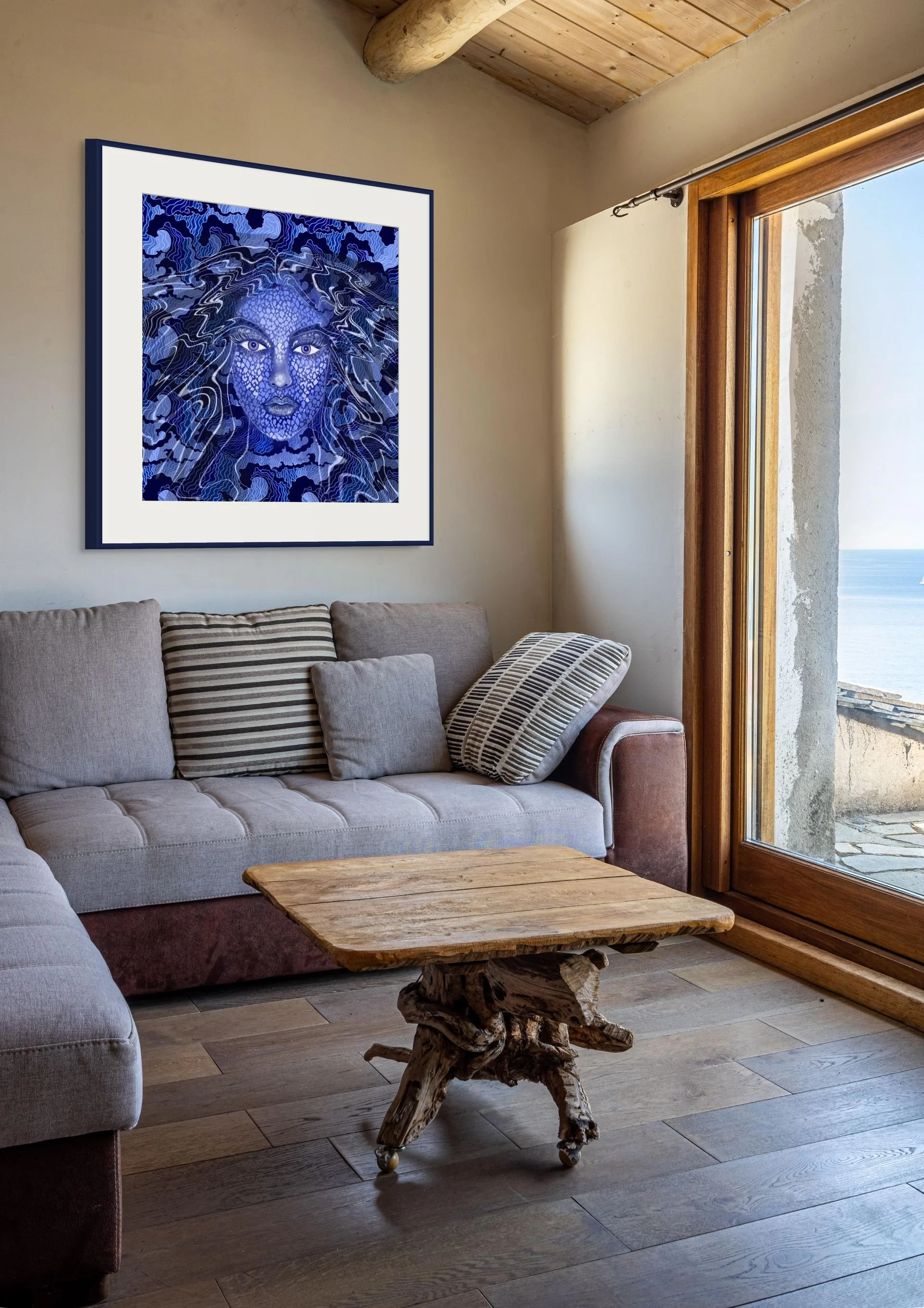 Blue celestial goddess wall art displayed in a modern living room with ocean-inspired abstract textures and mystical feminine decor.