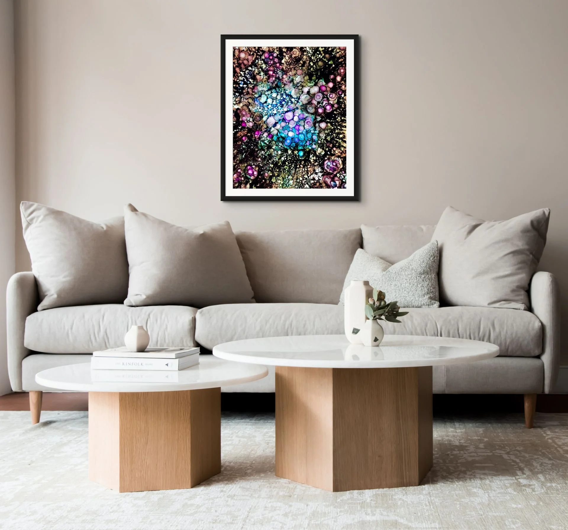 Molecules of Love abstract print in black frame above neutral sofa in modern living room