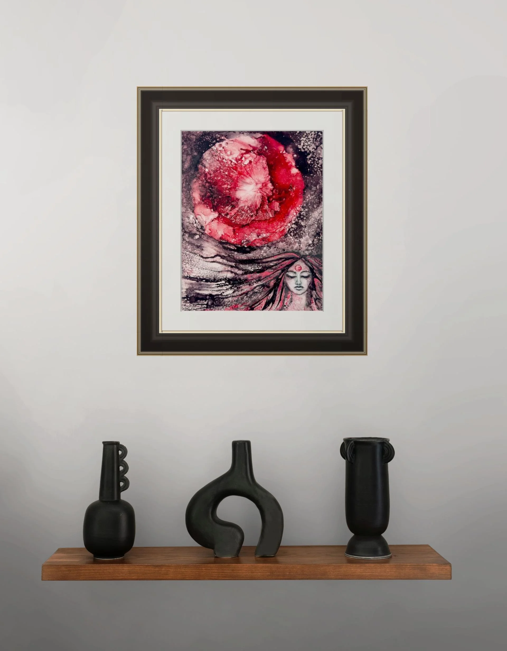 Strawberry Moon original fine art in black and gold frame on a shelf with modern black ceramic vases