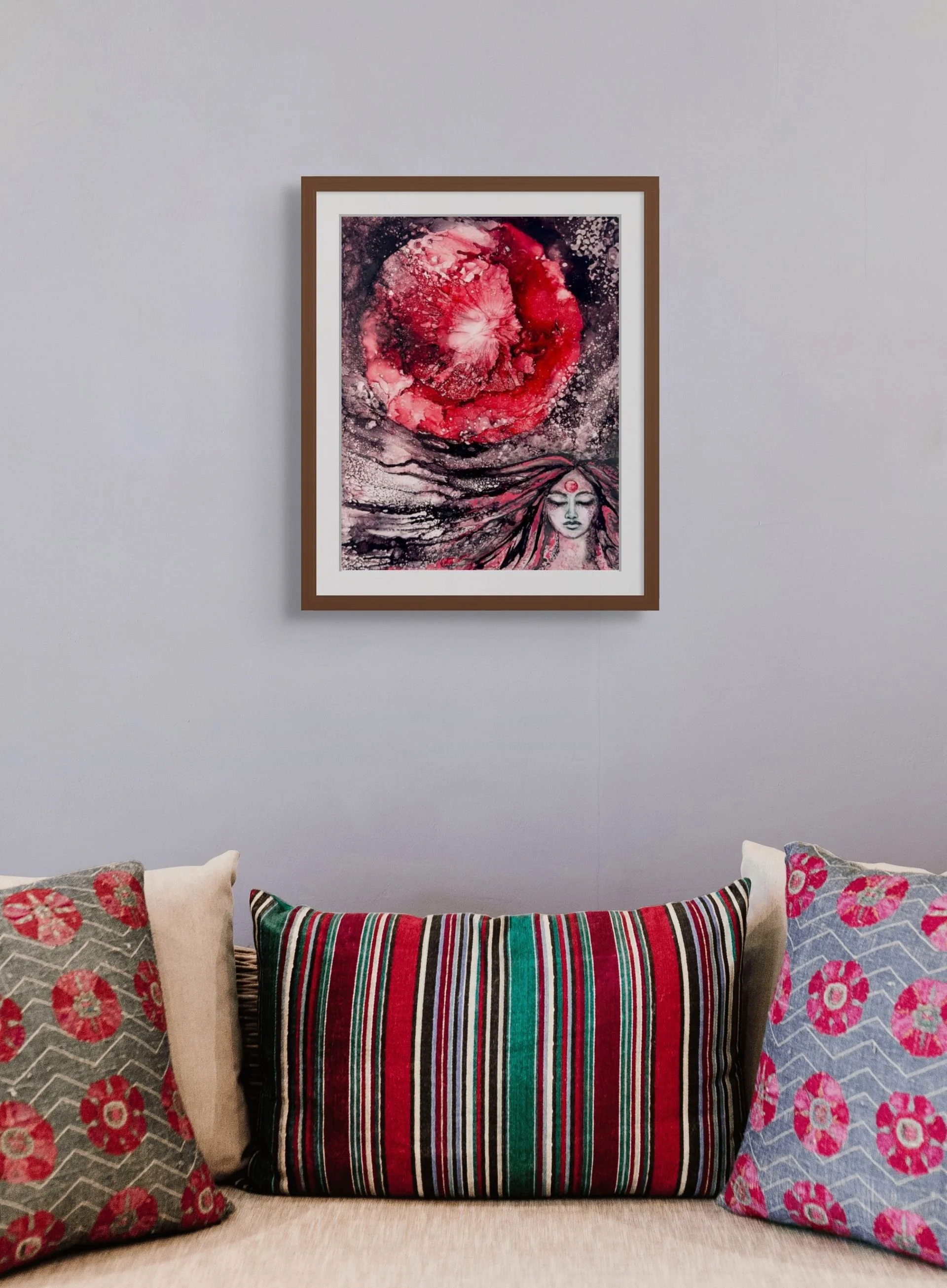 Strawberry Moon abstract woman painting in walnut frame above a sofa with red and teal pillows