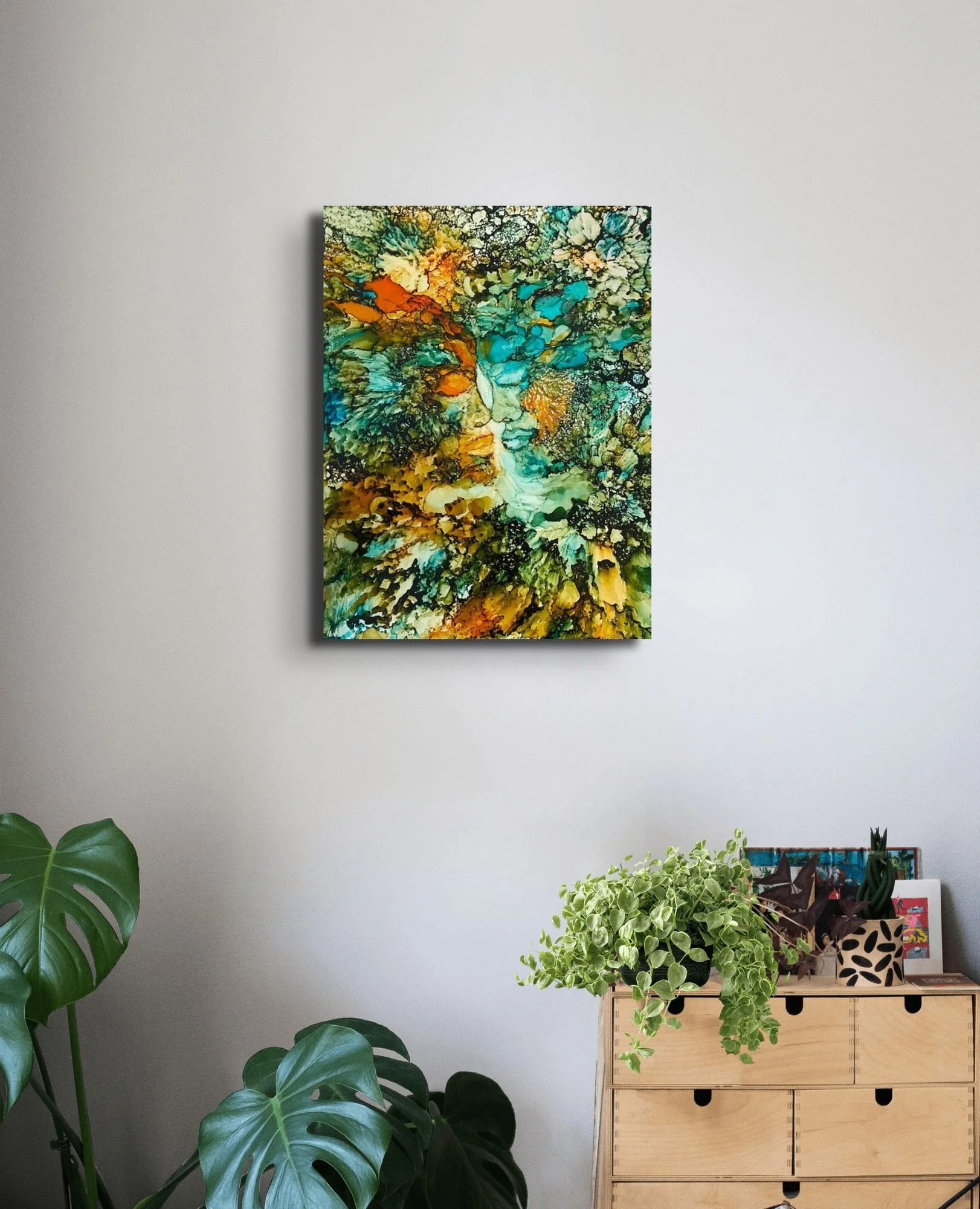 Contemporary abstract wall art with green, teal, and gold textures displayed in a stylish modern home interior.
