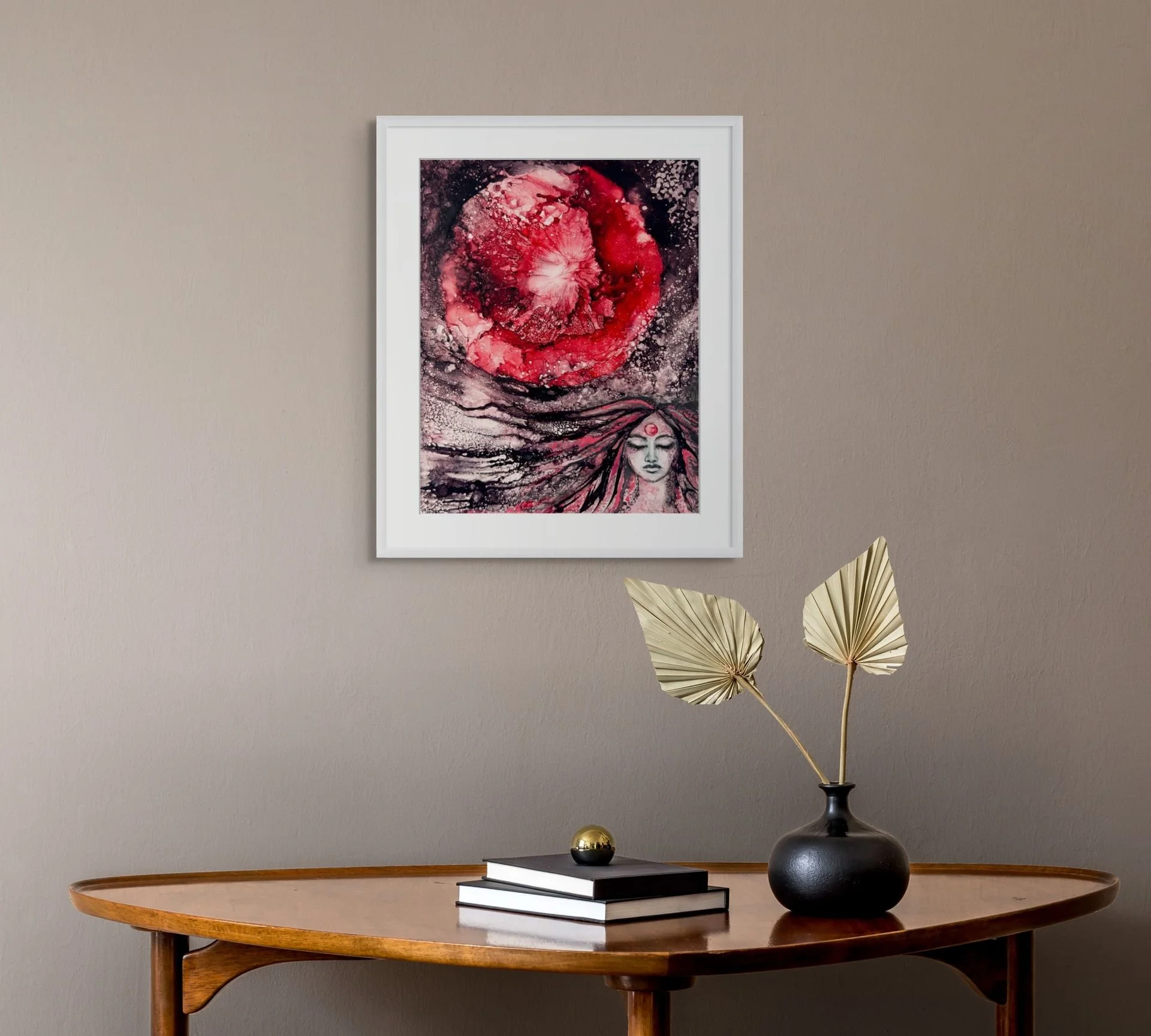 Strawberry Moon abstract woman painting in walnut frame above a sofa with red and teal pillows