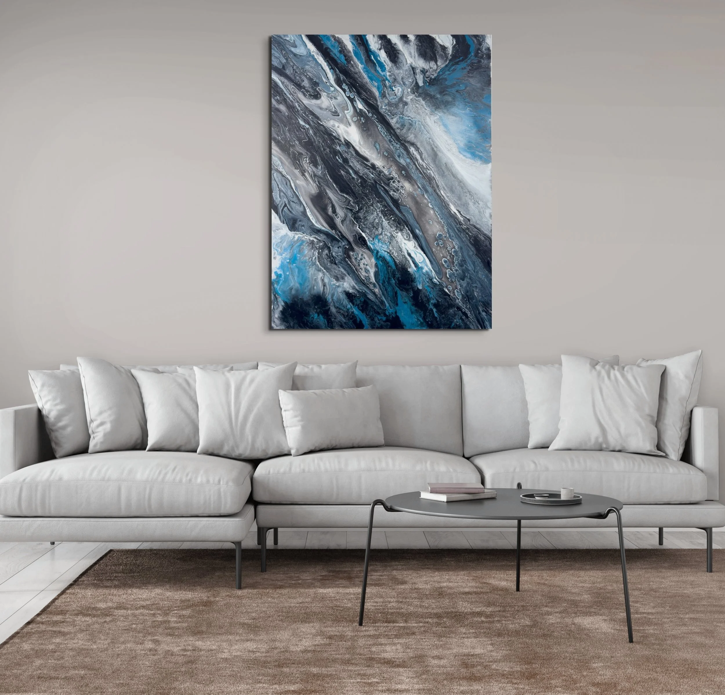 Modern abstract wall art with black, charcoal, silver, and electric blue flowing textures displayed above a white sofa in a contemporary living room home decor setting.