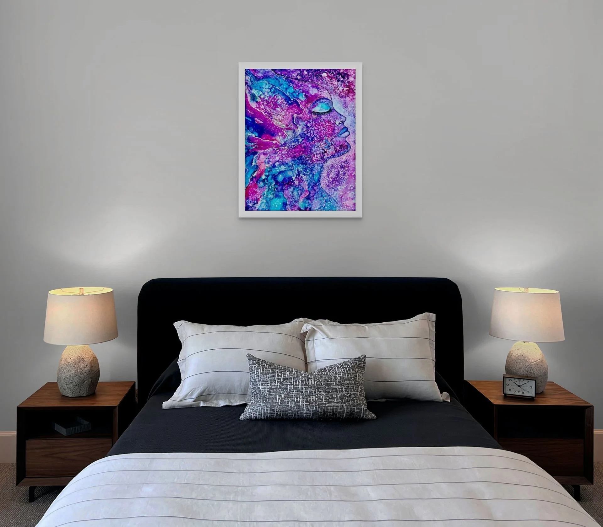 Pink and purple celestial abstract wall art hanging above a bed in a modern bedroom with vibrant spiritual decor styling.