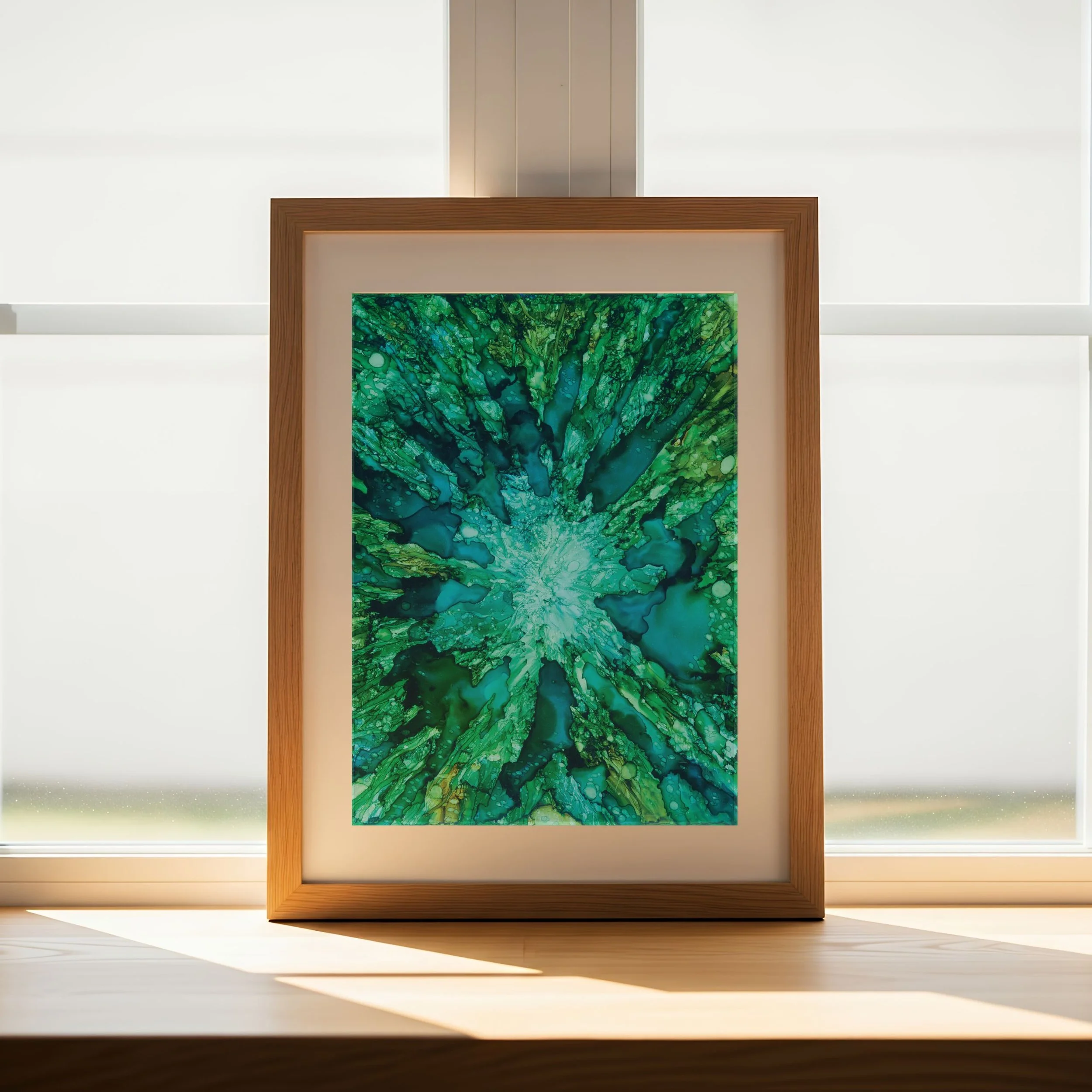 The Pull Inward abstract alcohol ink art print in natural wood frame with emerald green and teal tones by Nadeane Friend