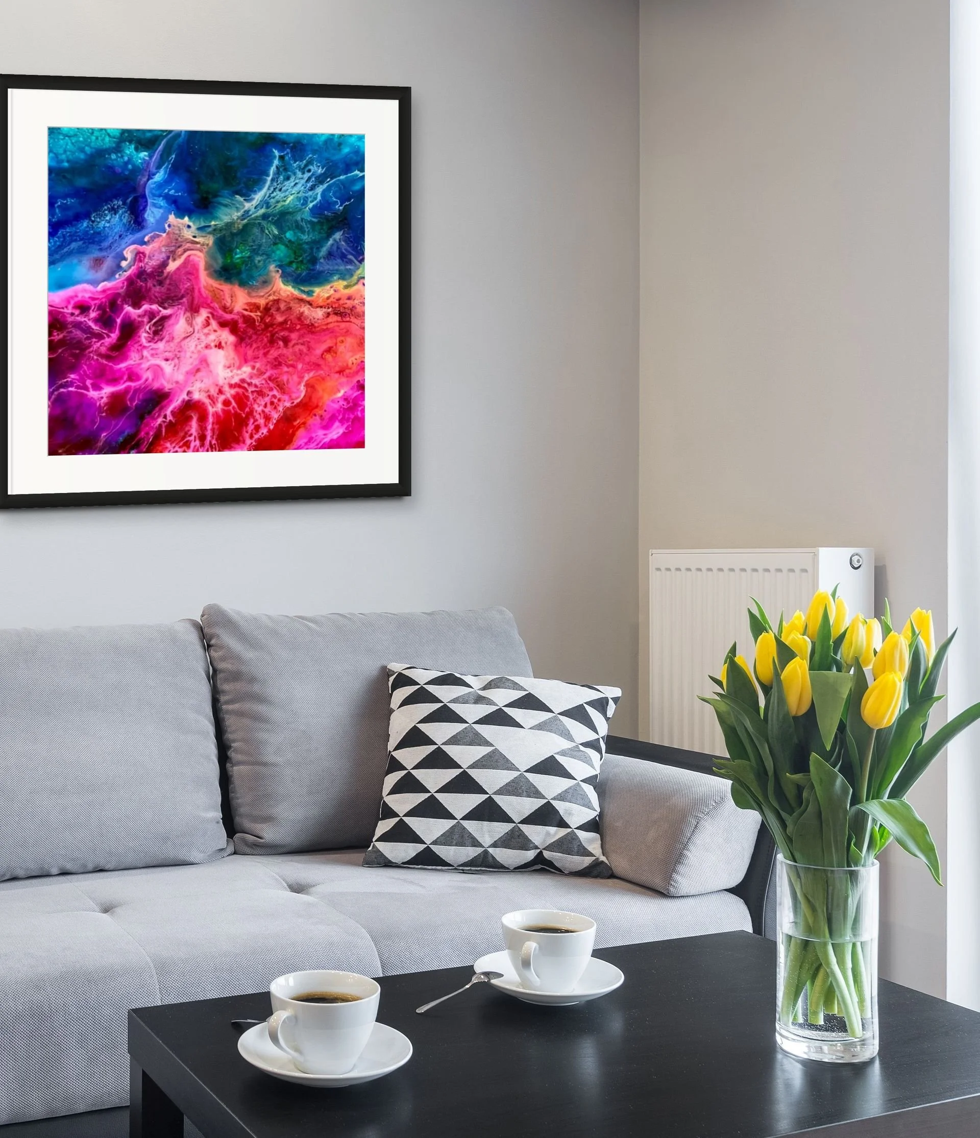 Colorful abstract wall art displayed in a modern living room with vibrant pink and turquoise textures and bold contemporary decor styling.