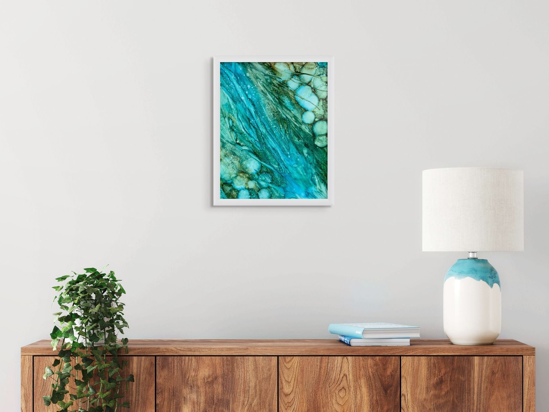 Blue and green abstract coastal wall art displayed in a modern home interior with soft neutral decor and ocean-inspired styling.