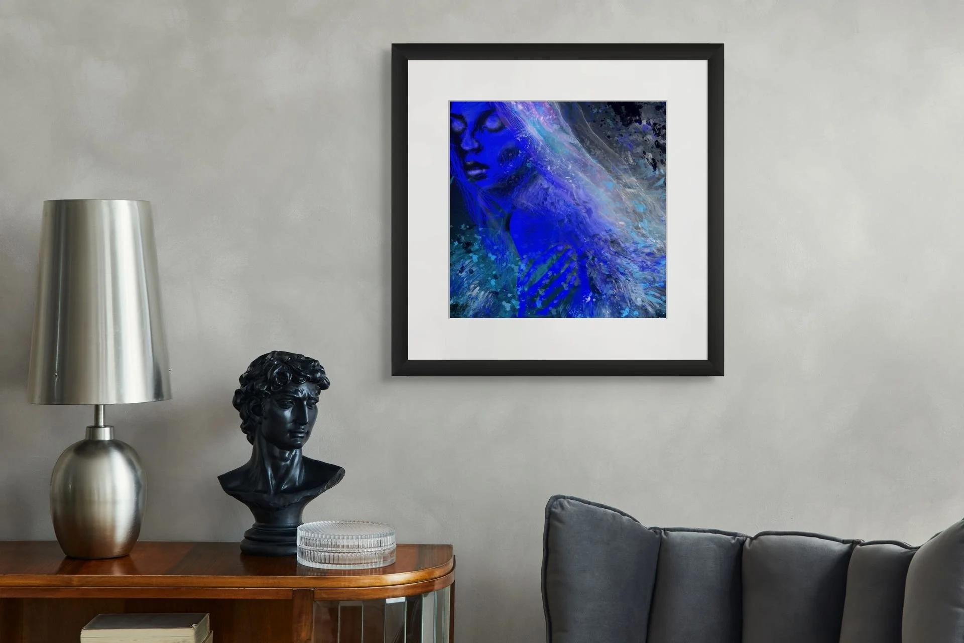 Blue coastal woman portrait wall art displayed in a modern living room with flowing ocean textures and calming beach house decor.