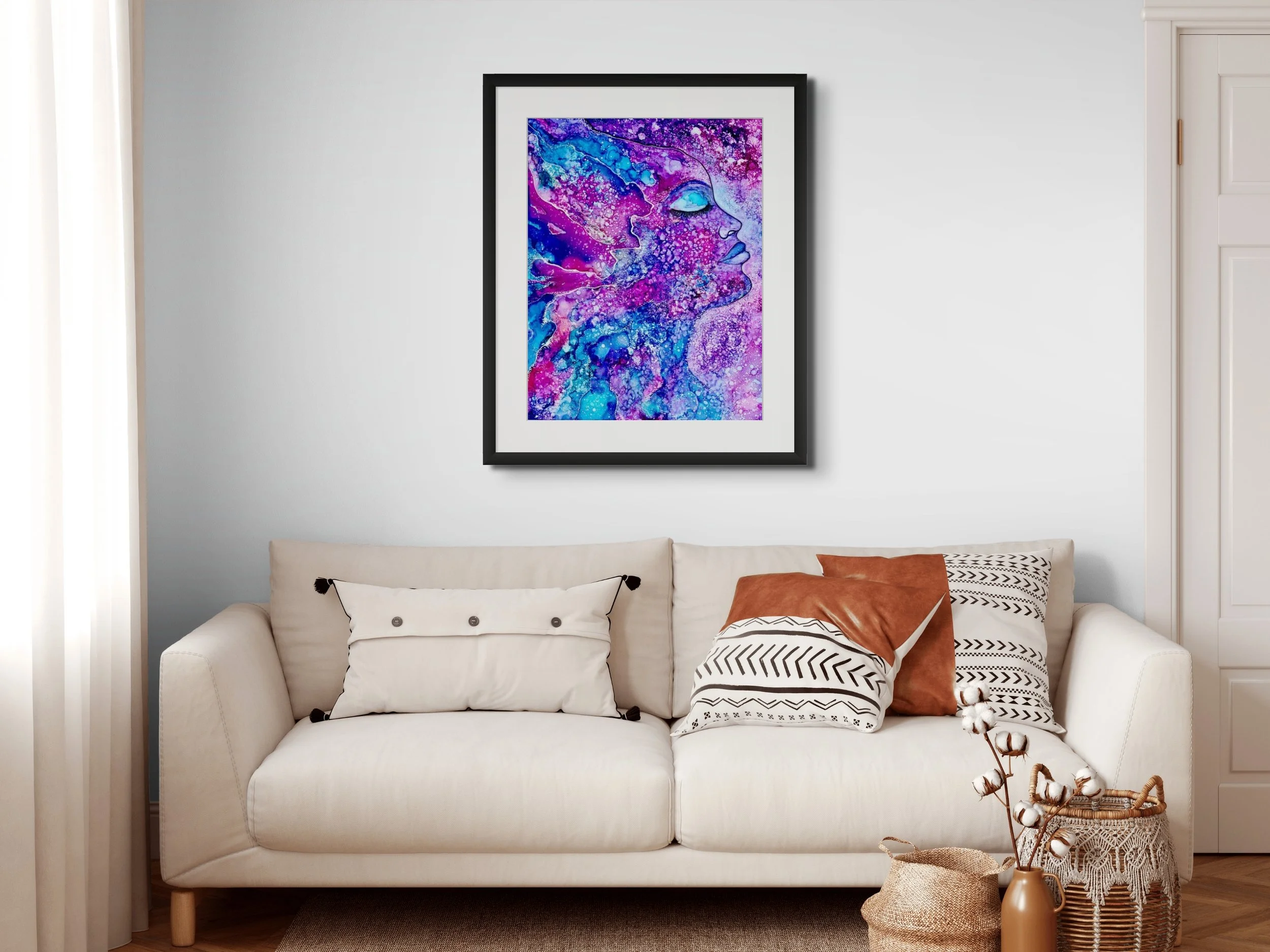Vibrant pink and blue abstract wall art displayed in a modern living room with cosmic textures and colorful contemporary home decor.